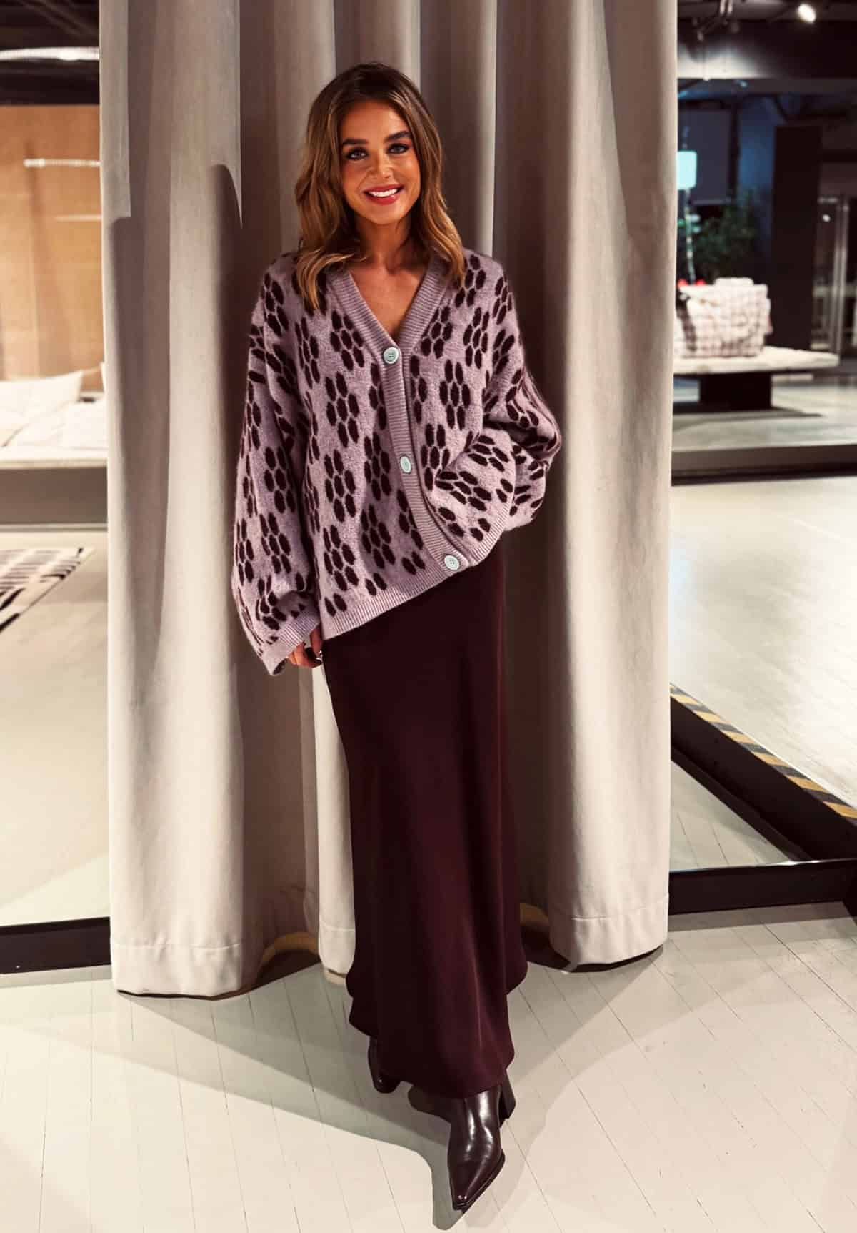 knit cardigan styled with a midi skirt and ankle boots