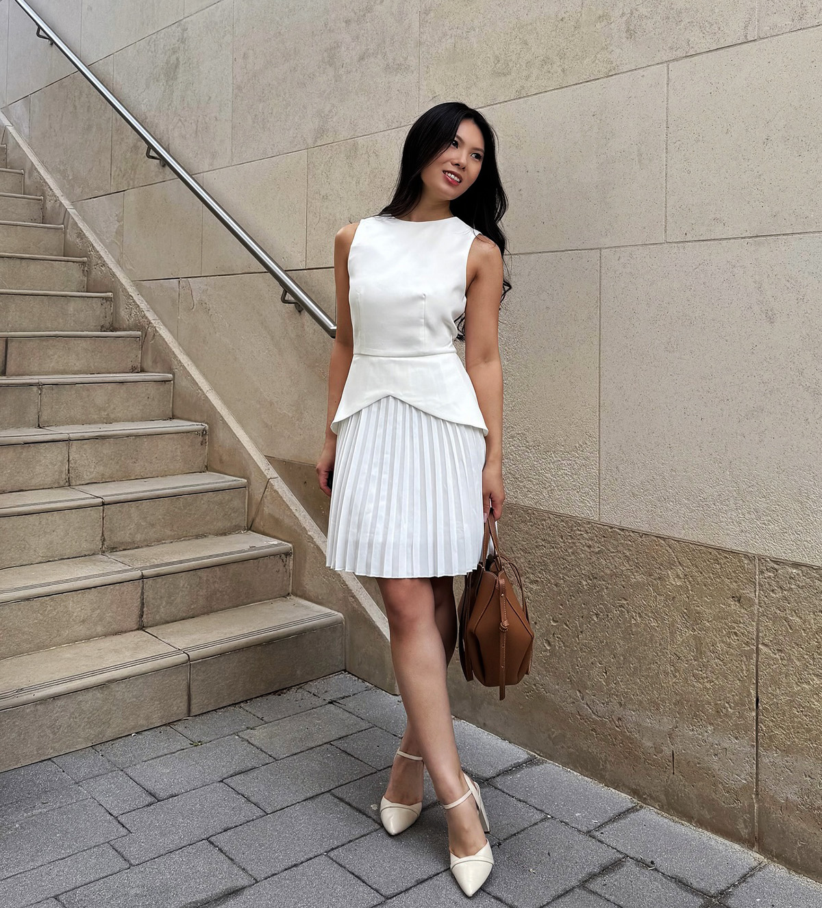 sleeveless white top with pleated skirt for a polished work outfit