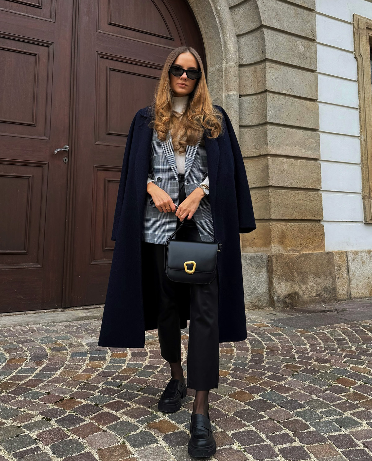 long navy coat layered over blazer for a classy office look