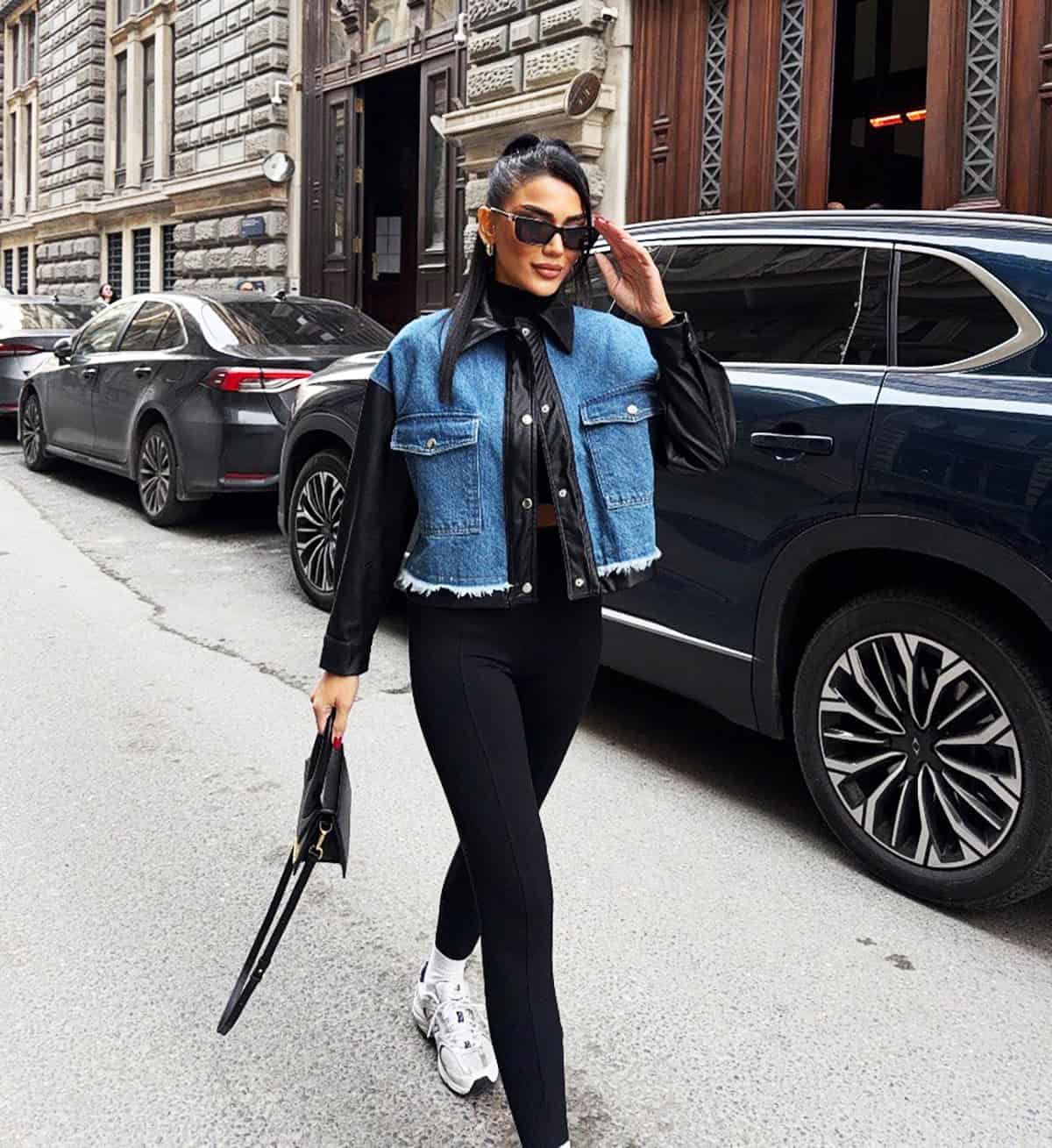 cute sporty outfit with black leggings for women styled with sneakers and a cropped denim jacket. cute outfits with leggings for women over 30