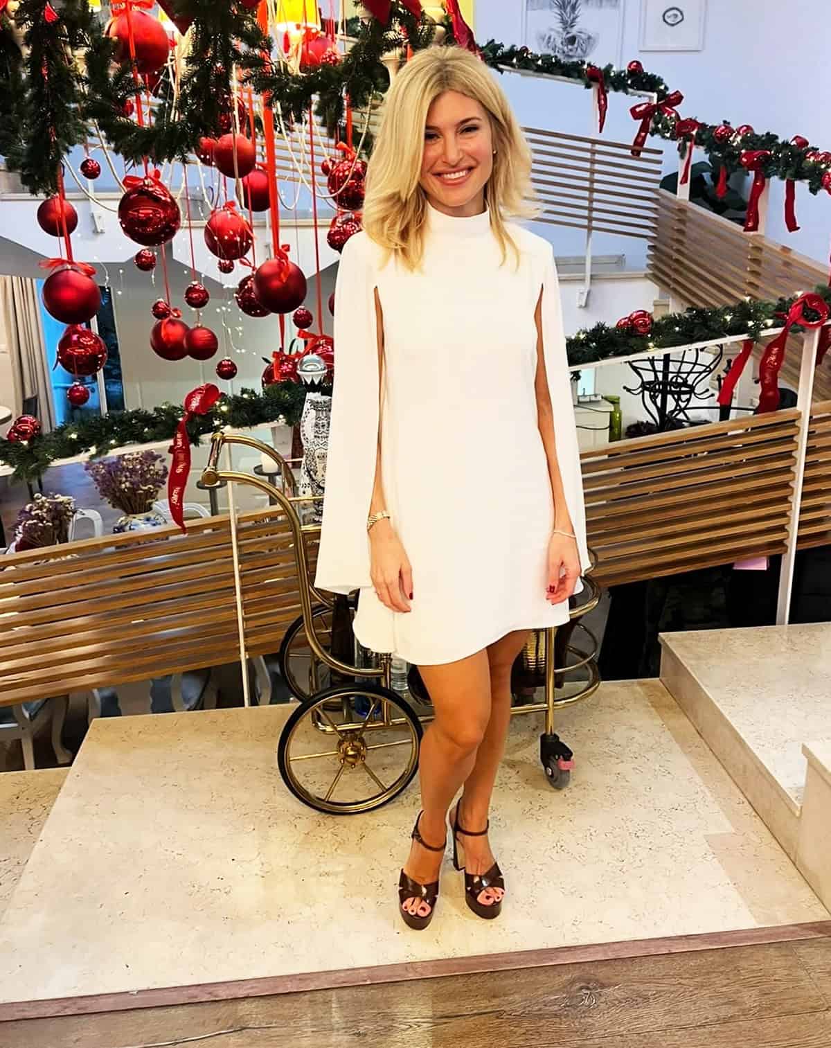 white cape sleeve cocktail dress styled for a winter holiday cocktail party