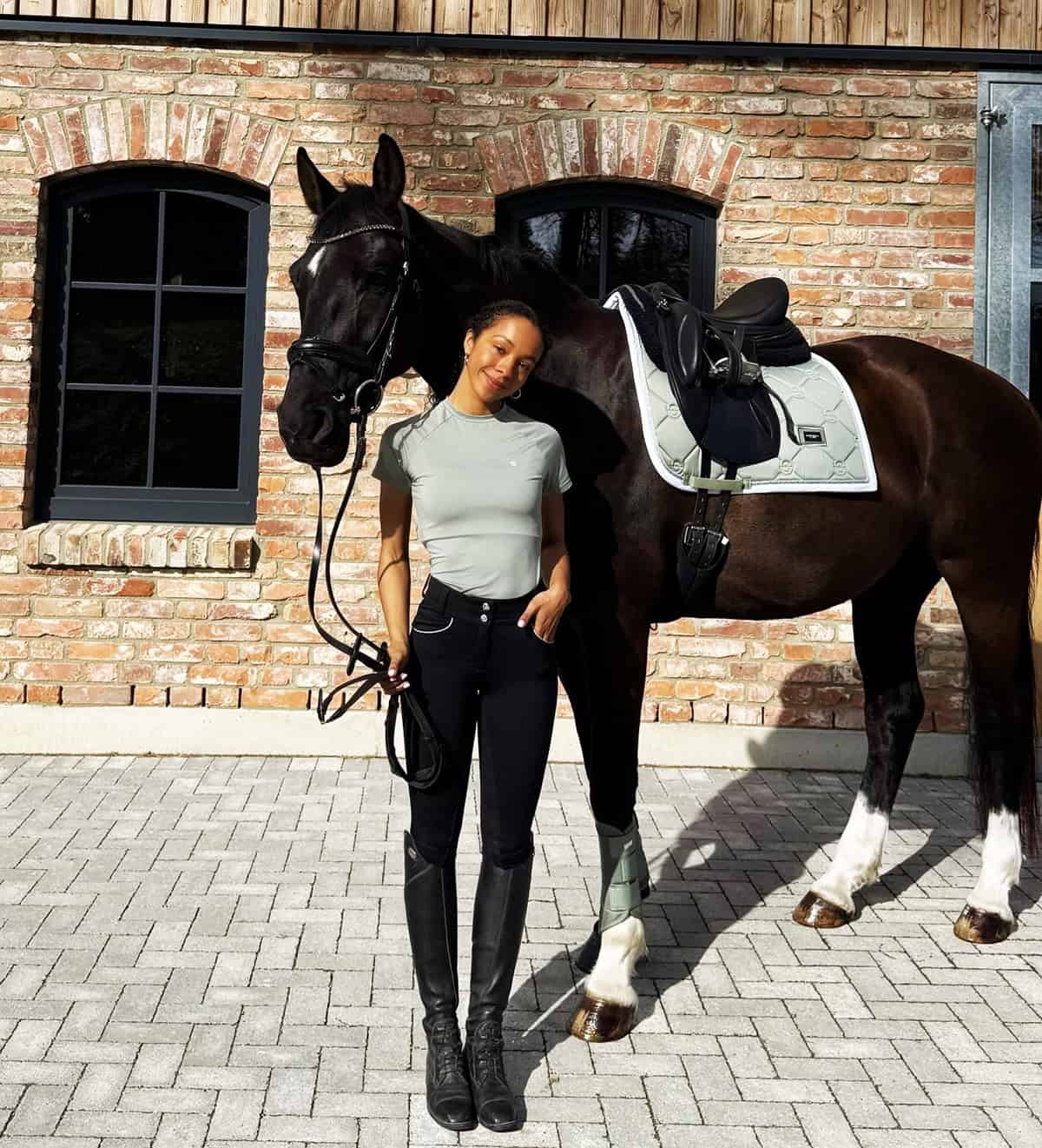 light grey top and black riding pants equestrian outfit ideas with soft neutral style