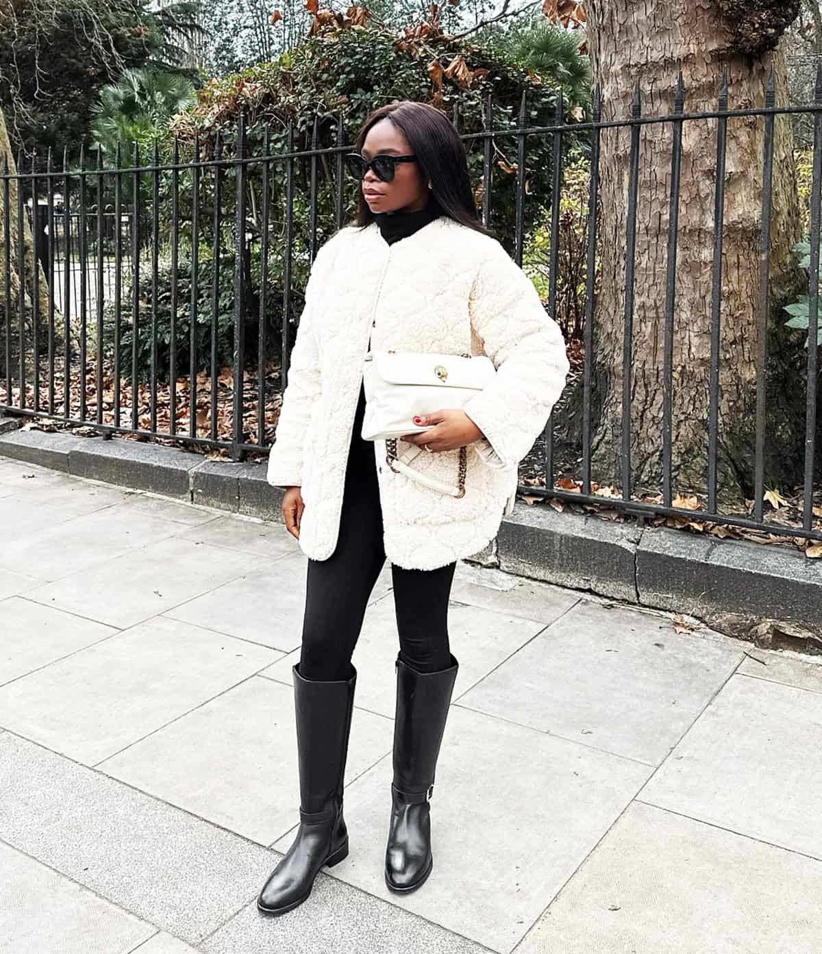 cute winter outfit with black leggings styled with a cream teddy coat and boots