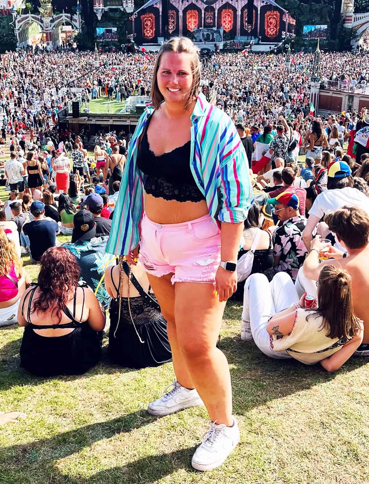 striped oversized shirt and pink denim shorts with lace bralette for festival outfits for plus size women