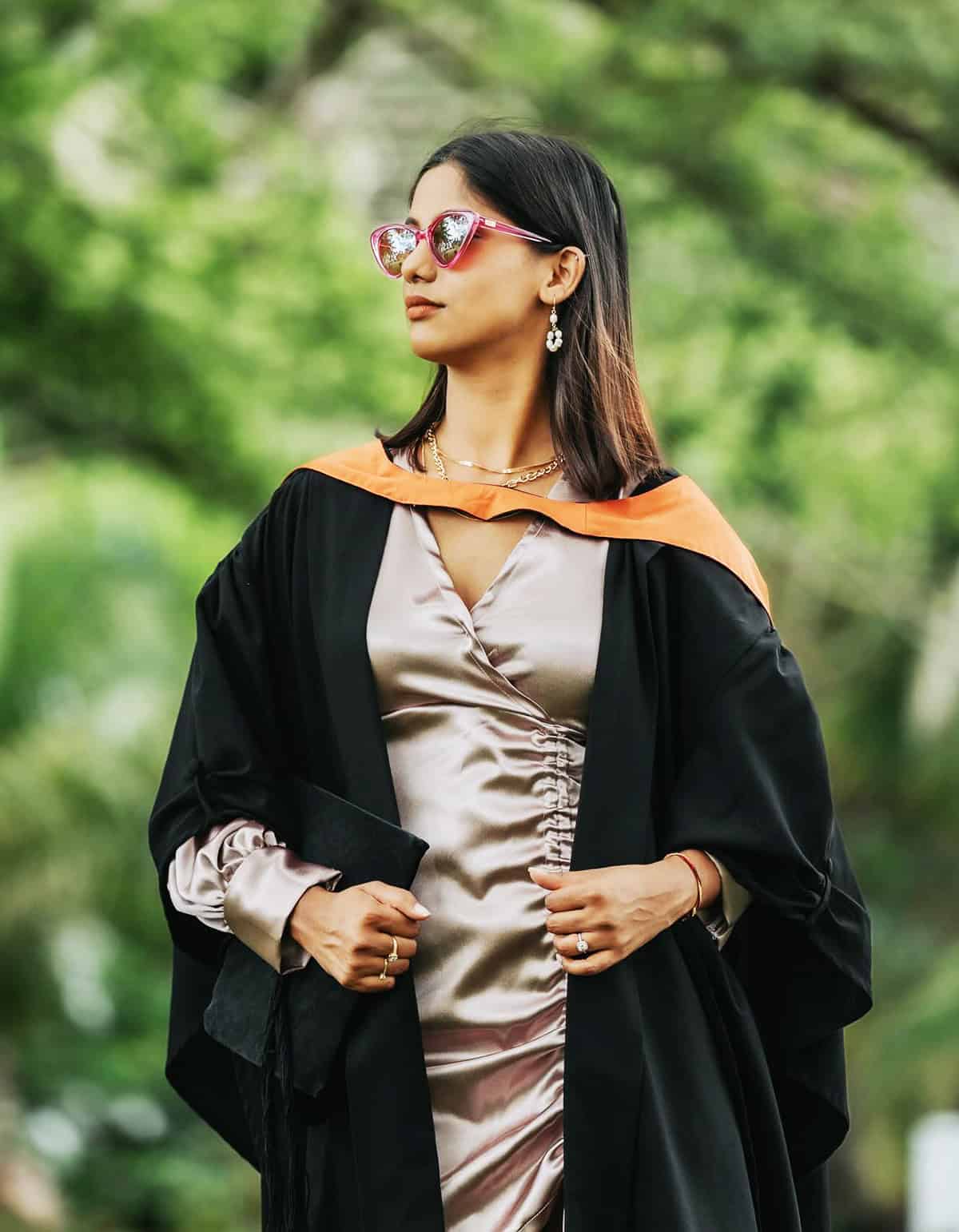 satin midi dress worn under graduation gown for outdoor ceremony outfit