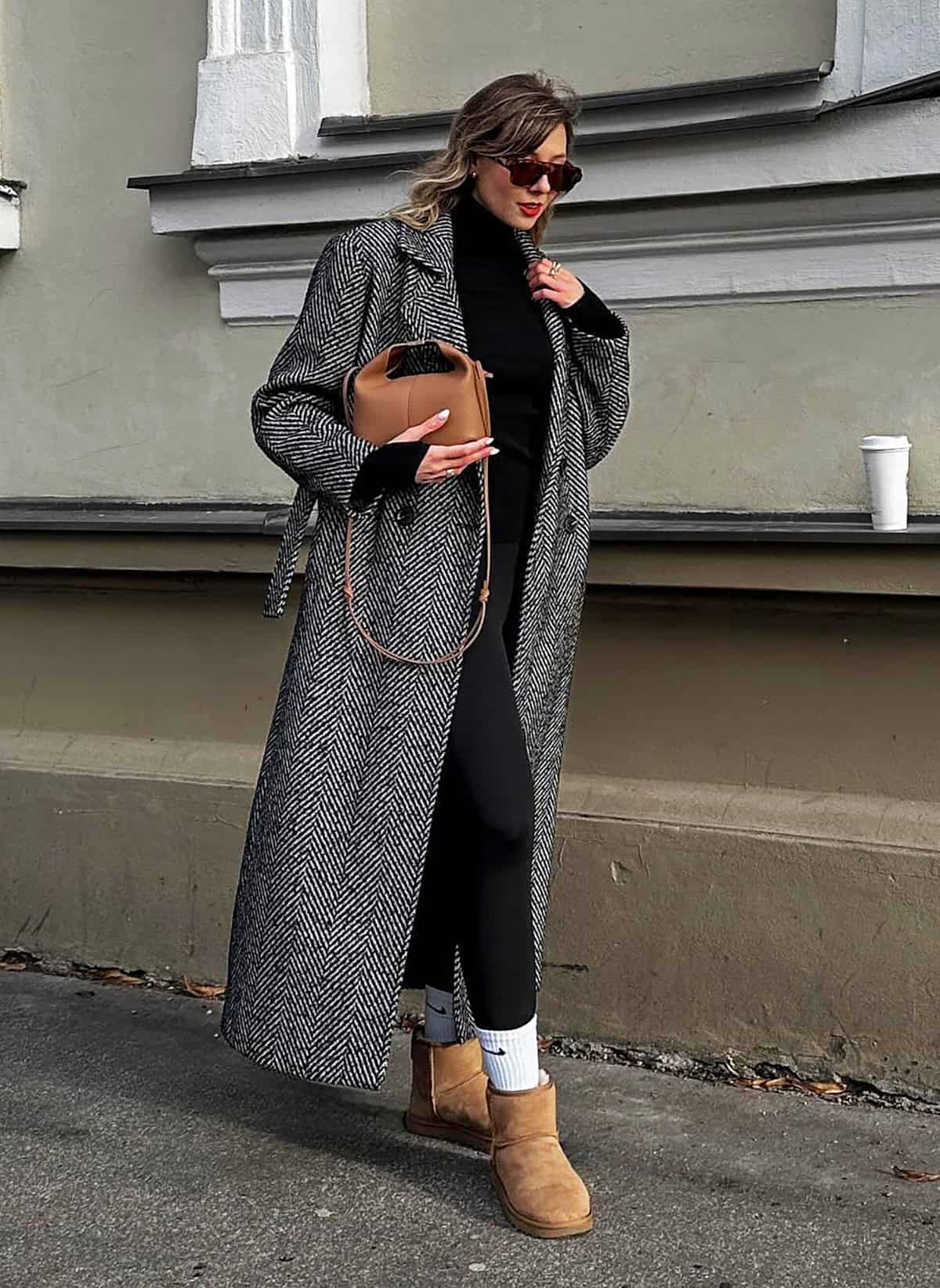 cute winter outfit with black leggings for women styled with a long coat and boots