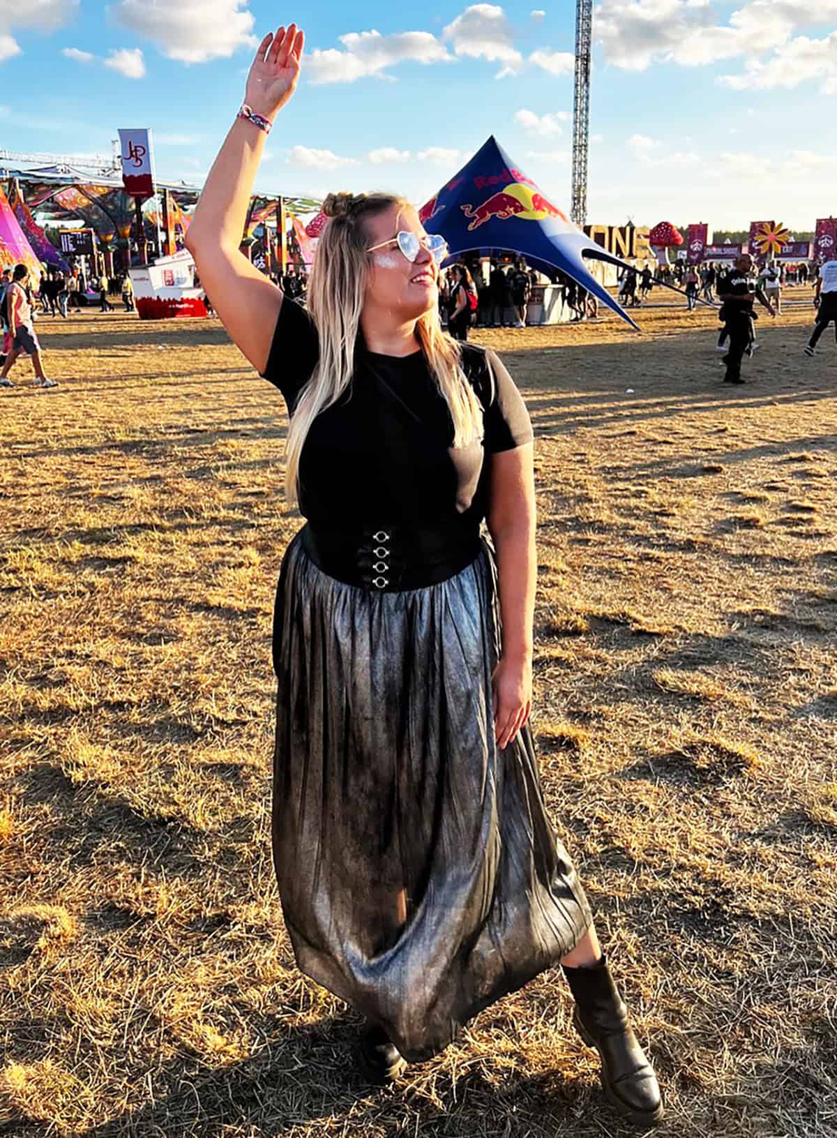 black corset top and metallic maxi skirt with boots for festival outfits for plus size women