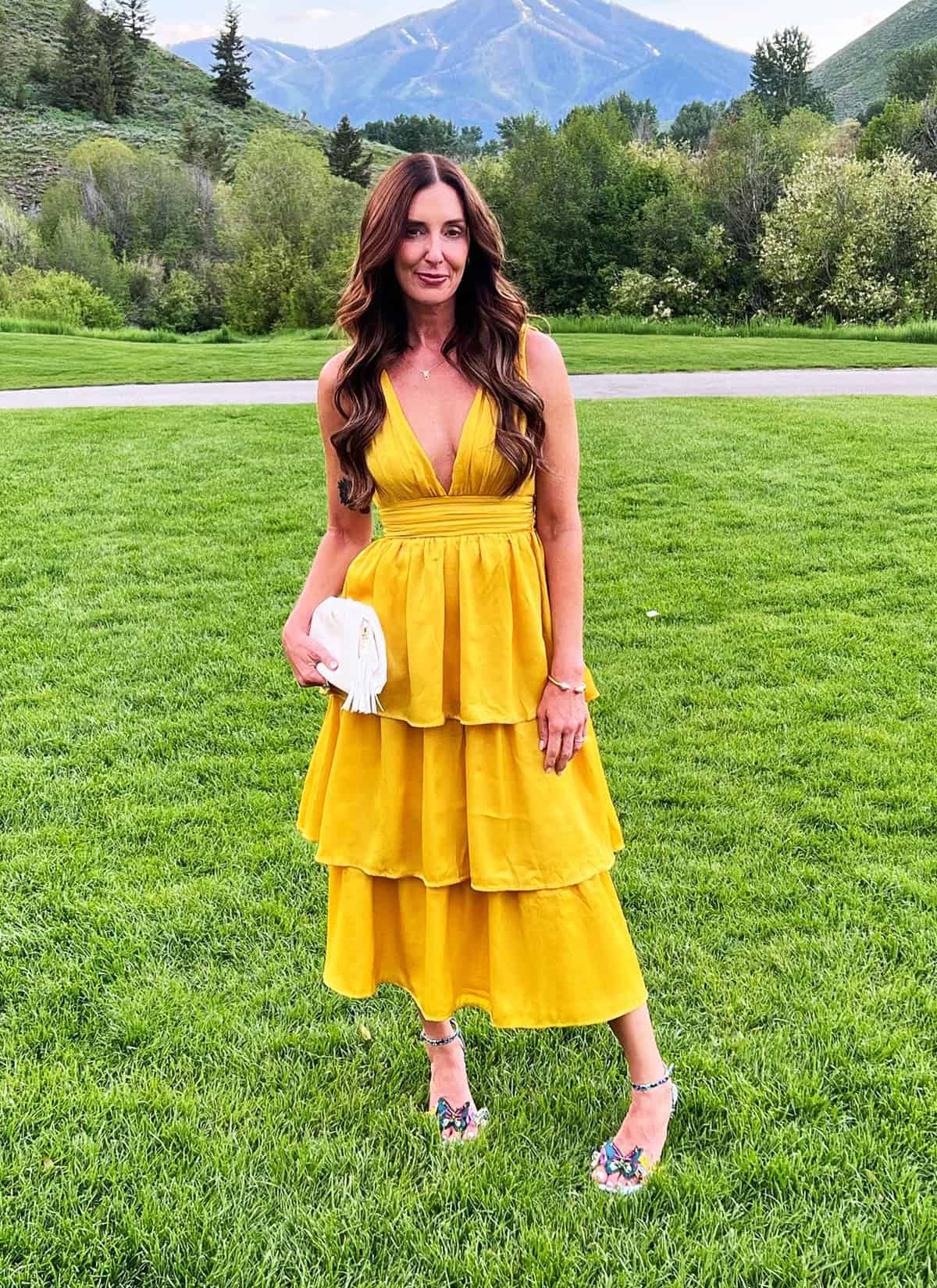 classy tiered mustard wedding guest dress with deep neckline