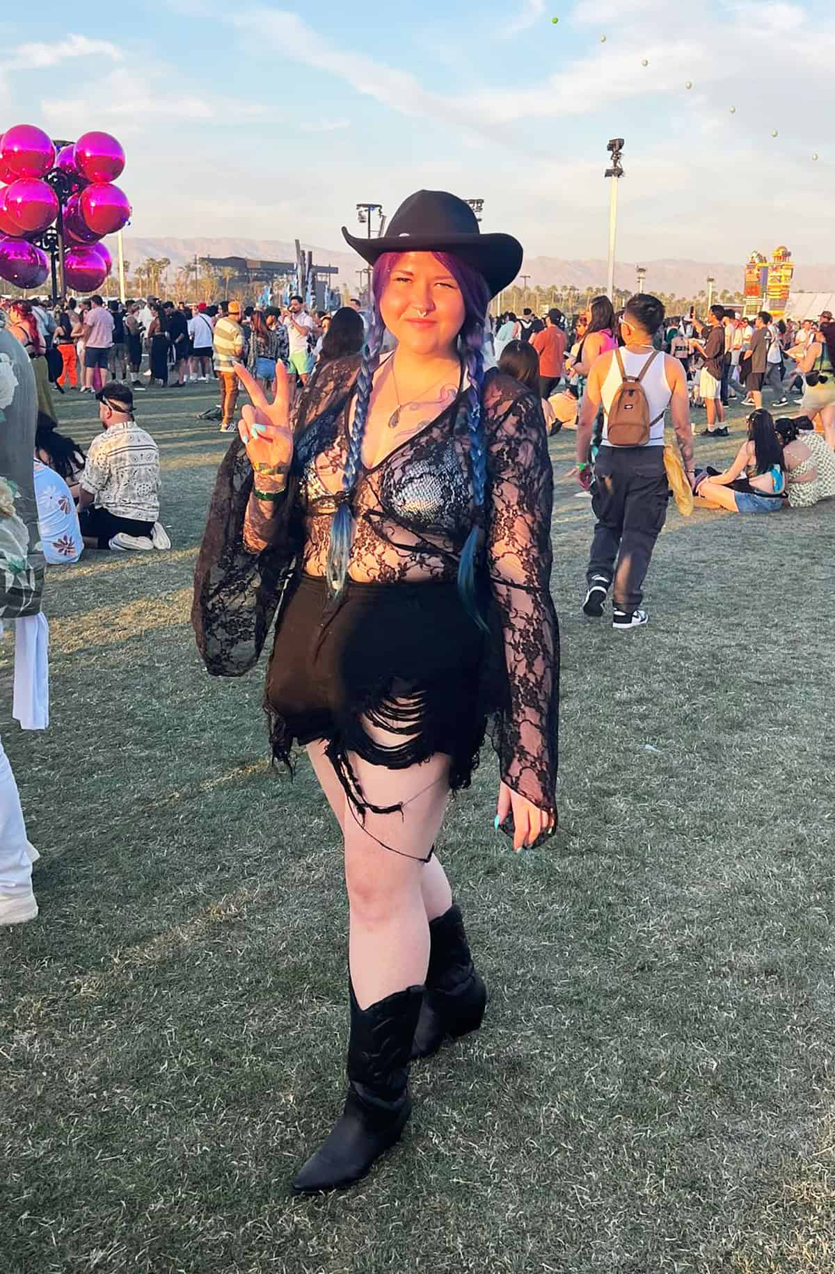 black lace top and denim shorts with cowboy boots for festival outfits for plus size women.