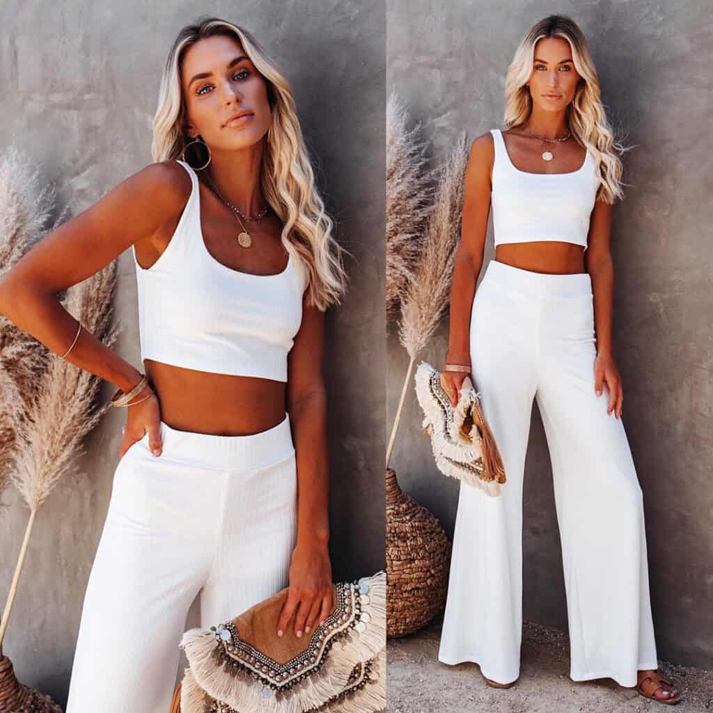 blonde model wearing white wide leg pants and white crop tank top