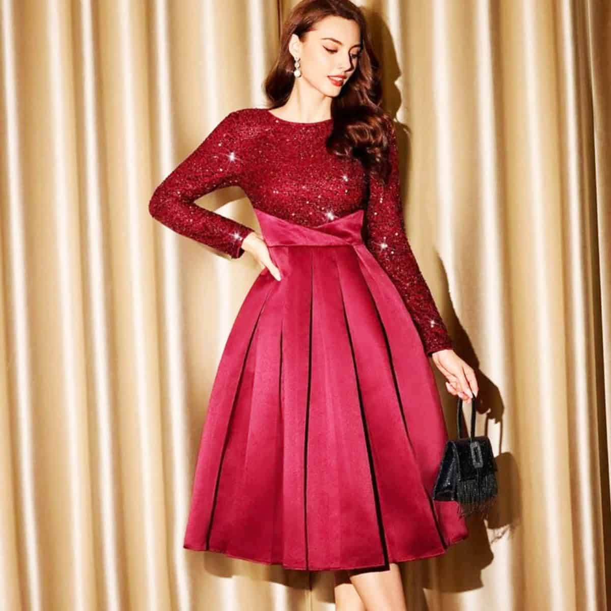 red long sleeve glitter cocktail dress with structured pleated skirt for a winter cocktail party outfit