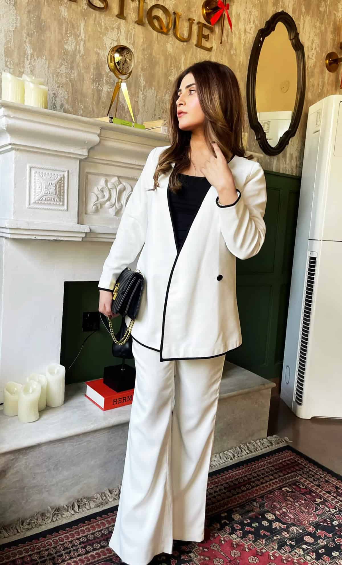 white wide-leg trouser suit with black trim detail and black inner top for office attire for women over 40