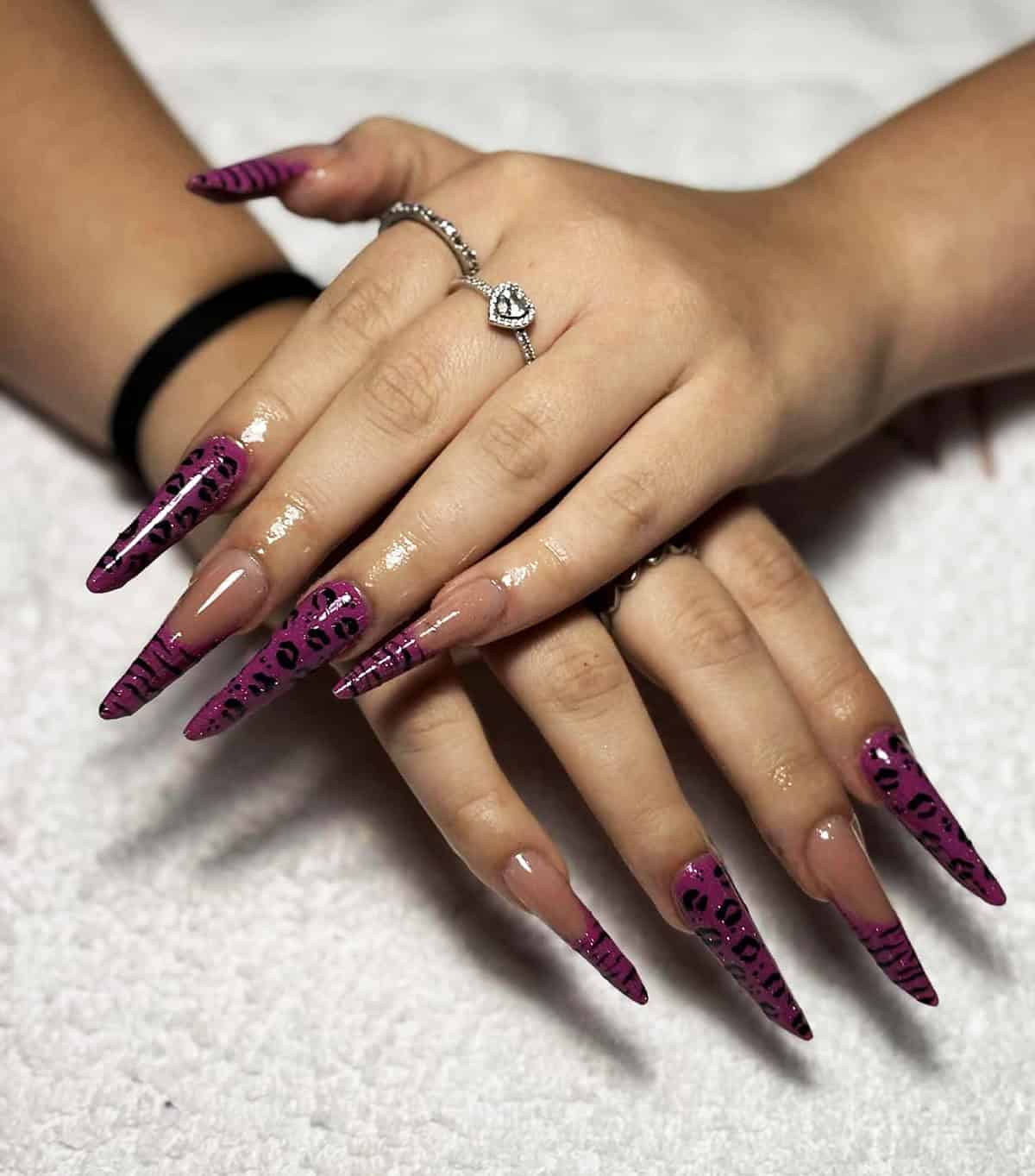 deep purple stiletto nails with black leopard print glossy finish baddie nails for summer
