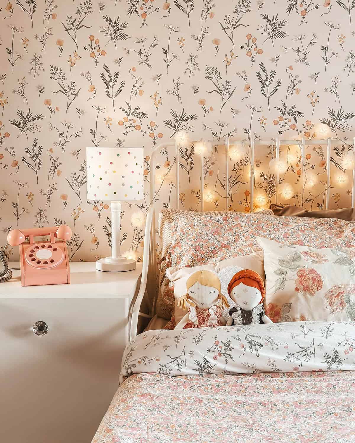 floral wallpaper and bedding with soft lighting and vintage accents cottagecore bedroom insp