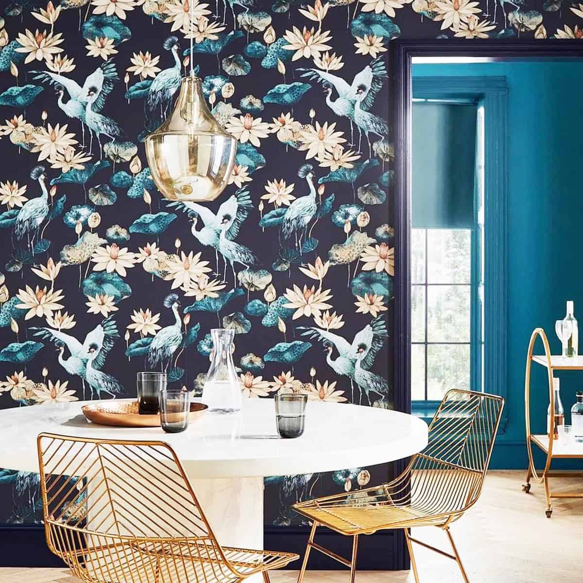 dark blue floral crane wallpaper in dining space with gold chairs dark blue wallpaper ideas home decor