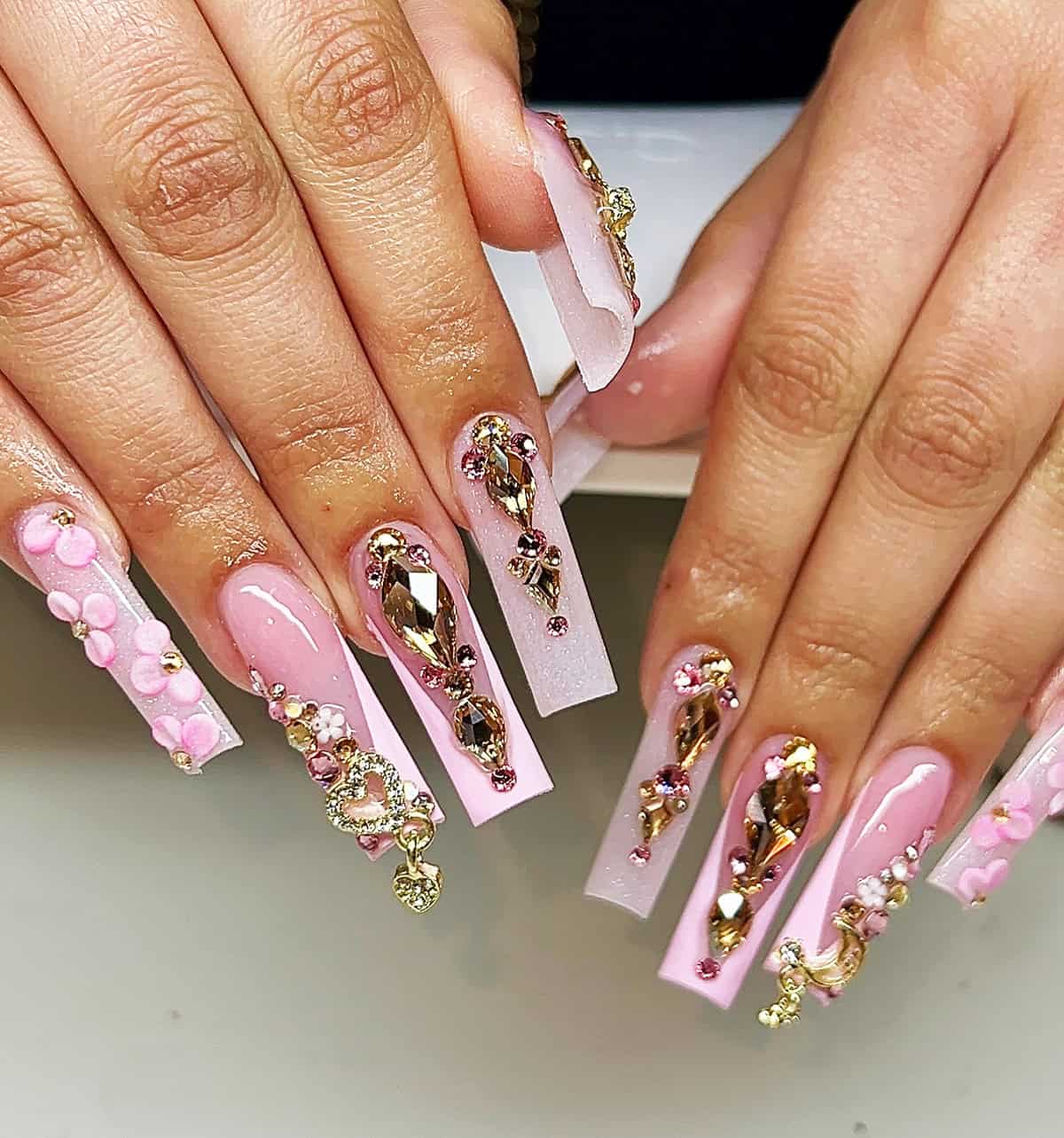 soft pink nails with gold and crystal embellishments glam princess nail design baddie nails for summer
