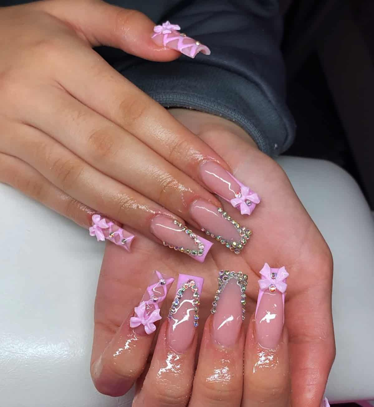 peachy nude almond nails with marble accents and 3D flower detail baddie nails for summer