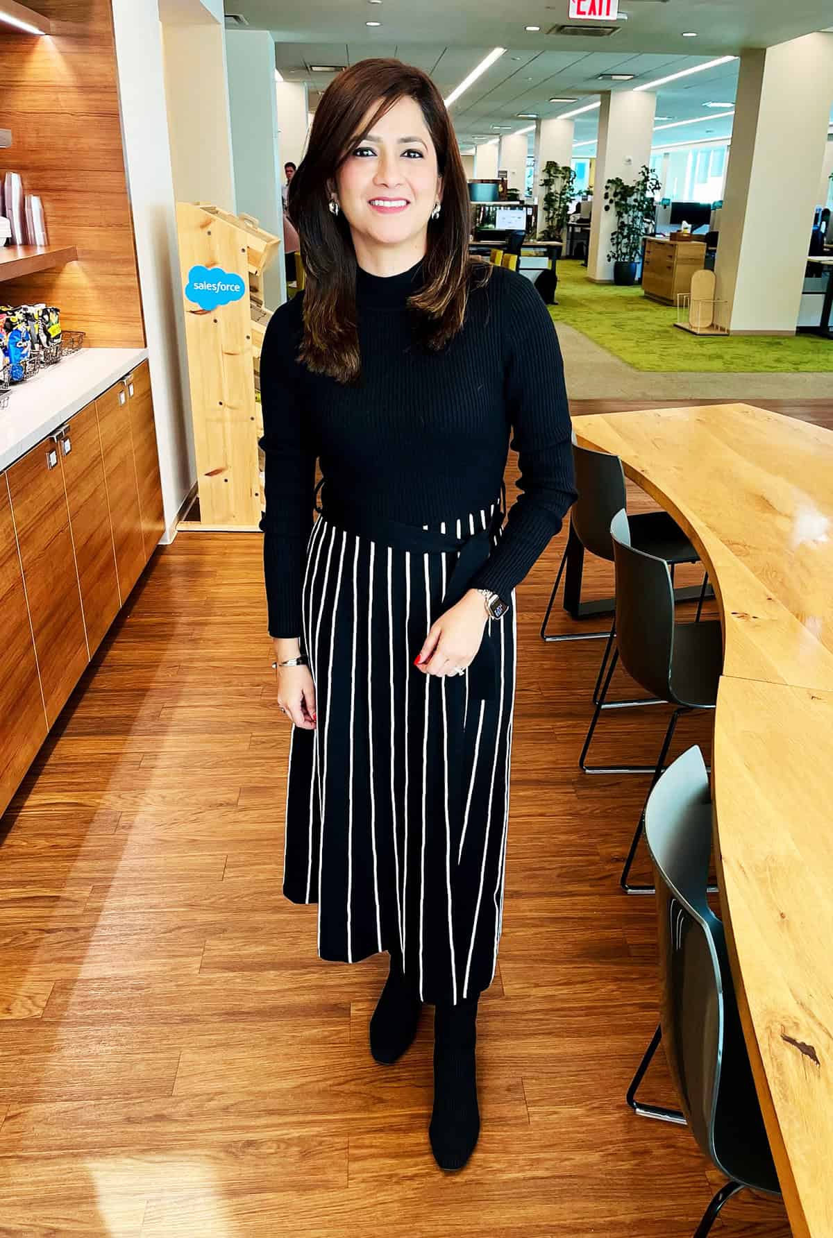 black ribbed mock-neck sweater with black and white vertical stripe pleated midi skirt for office attire for women over 40