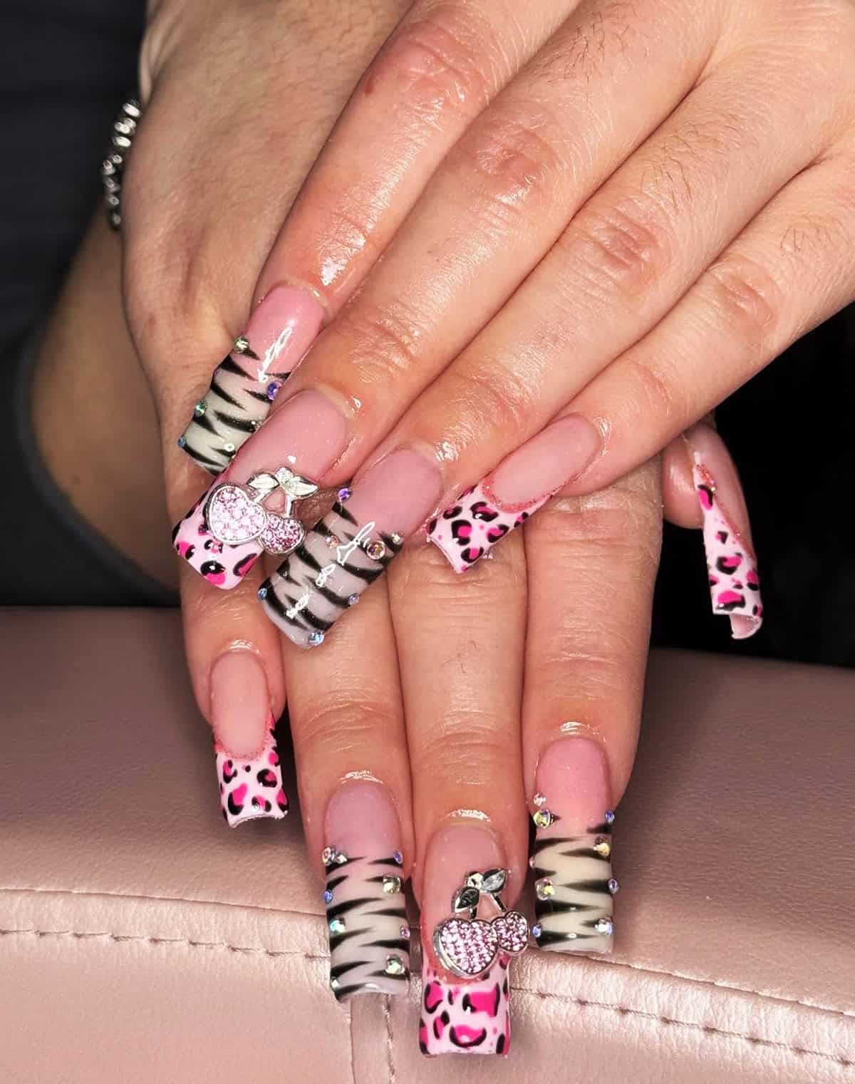 nails with zebra, pink leopard, and cherry charm details baddie nails for summer