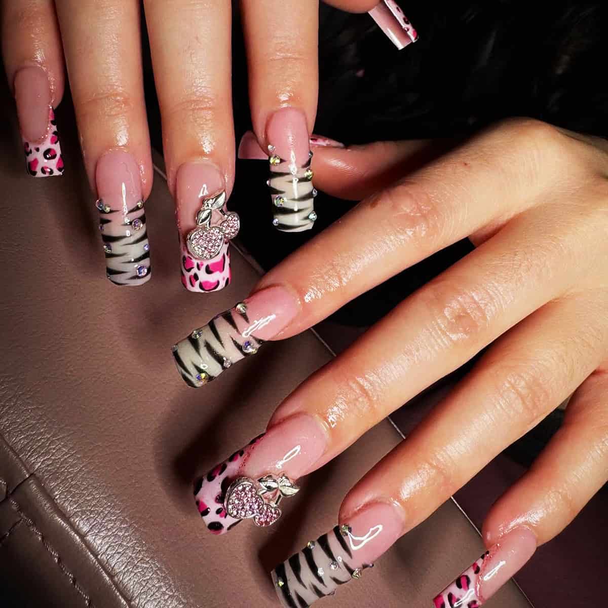 pink leopard and zebra print nails with cherry charms and rhinestones design baddie nails for summer