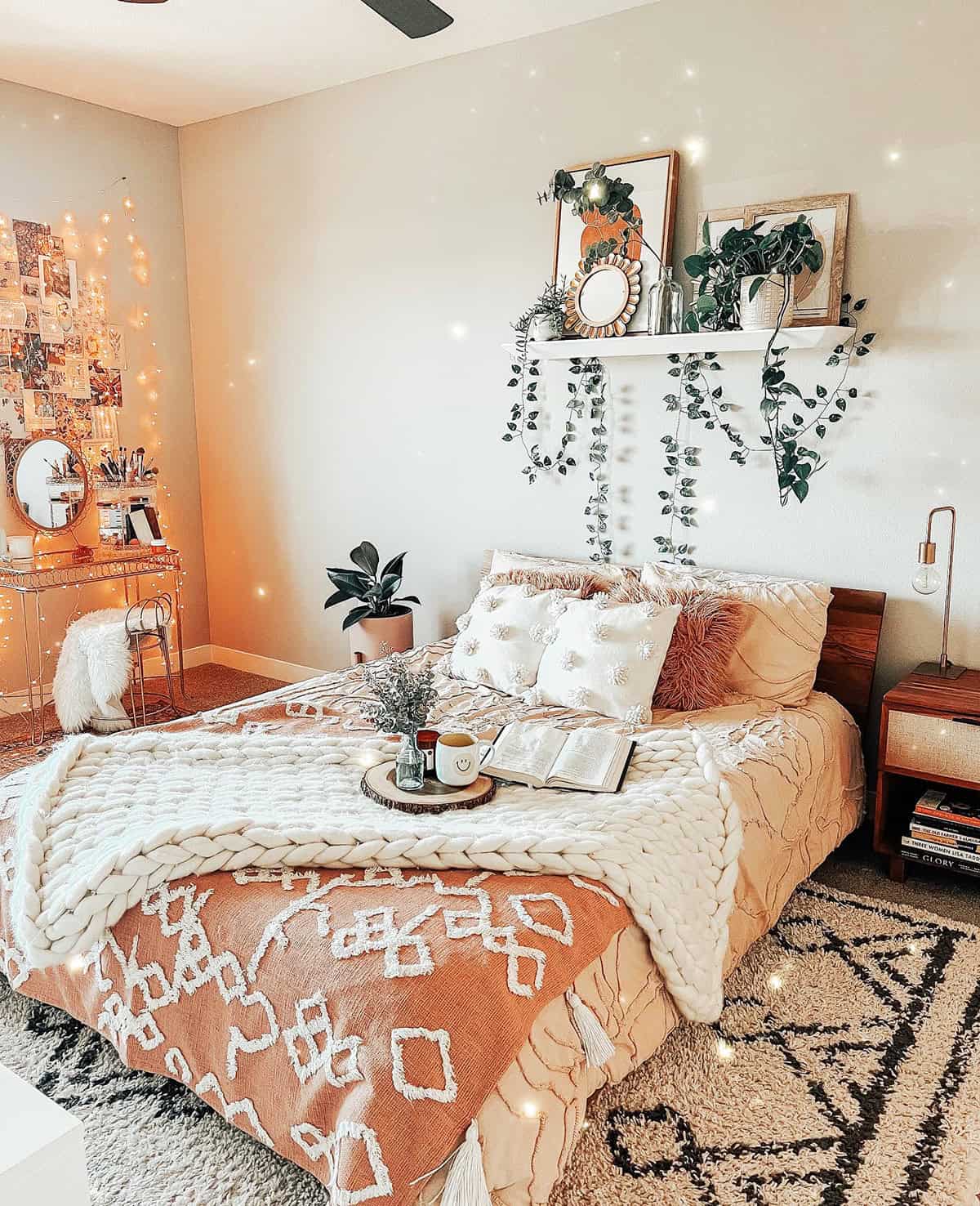layered bedding with chunky knit, string lights, plants, and cozy personal decor cottagecore bedroom insp