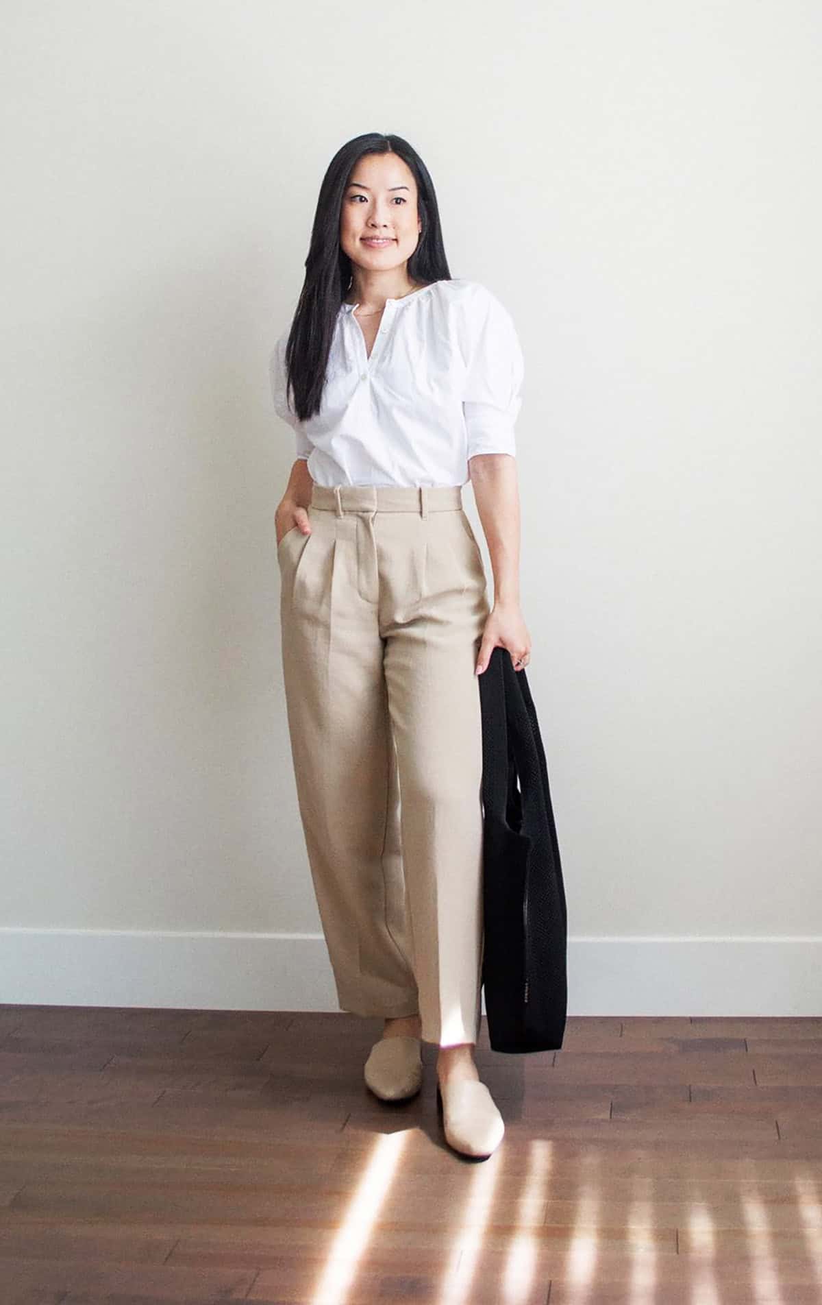 white puff-sleeve blouse with high-waisted wide-leg khaki trousers and nude slip-on mules for office attire for women over 40