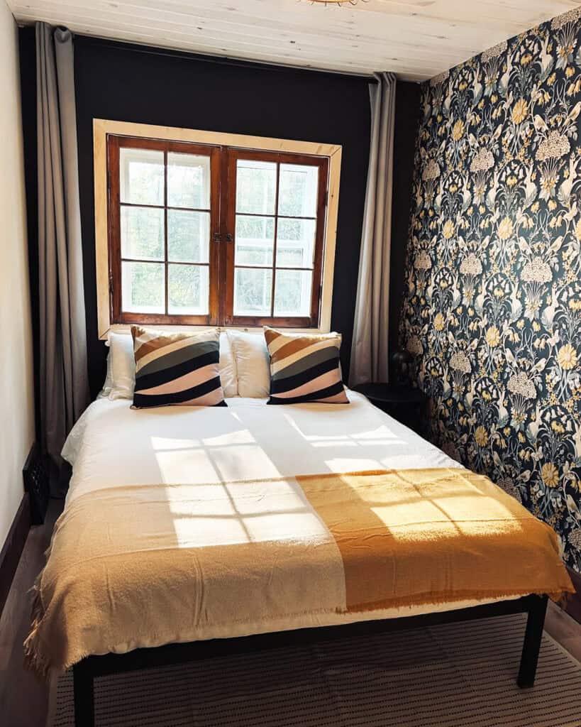 dark floral wallpaper with simple bedding and natural light contrast cottagecore bedroom insp