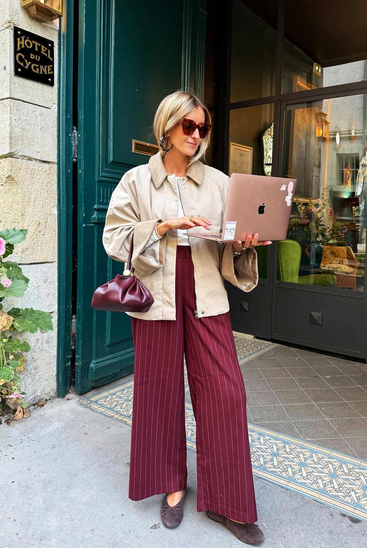burgundy wide-leg pinstripe trousers with white tee and beige coach jacket for office attire for women over 40