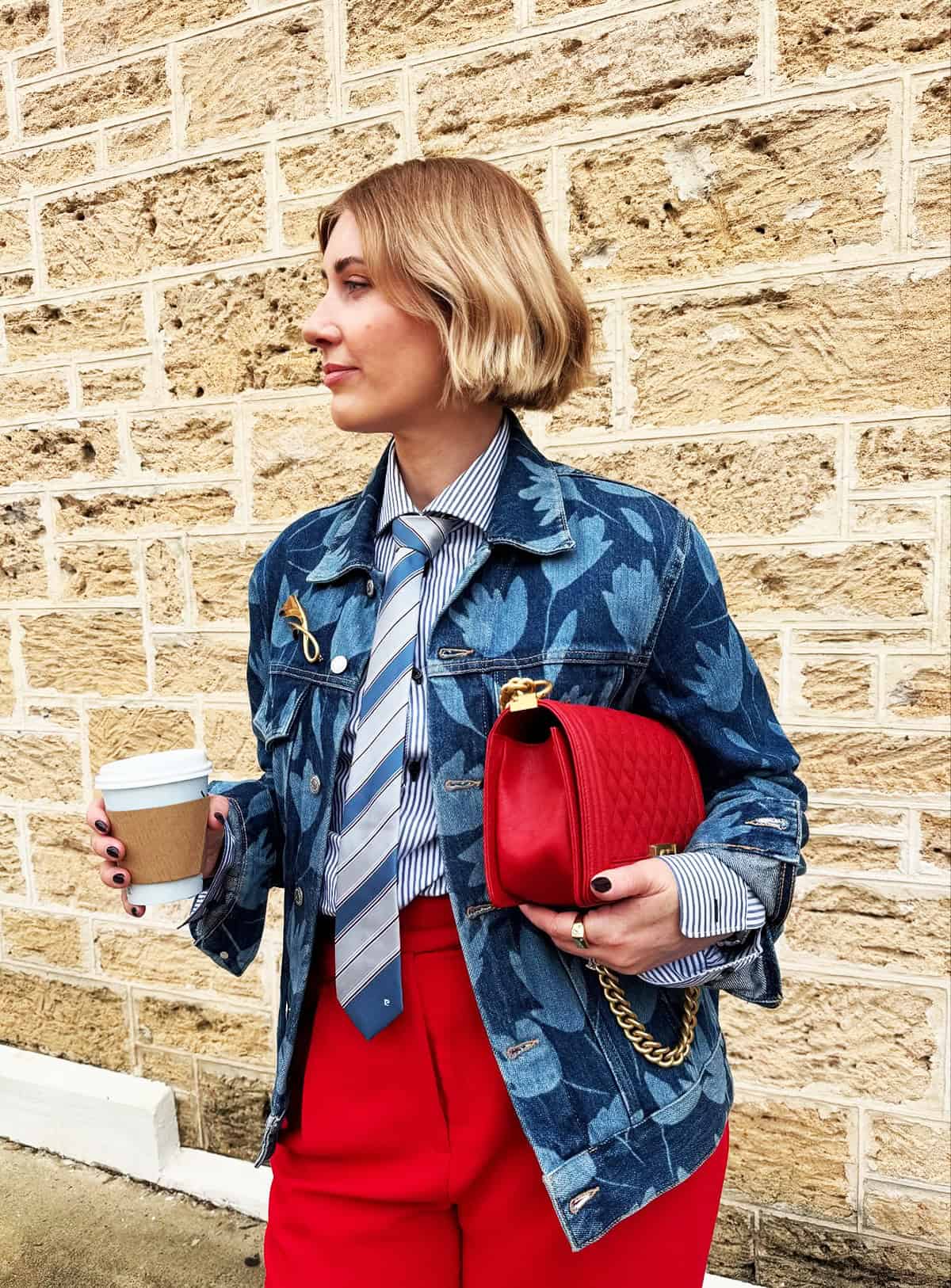 red wide-leg trousers with striped shirt, knotted tie and floral denim jacket for office attire for women over 40