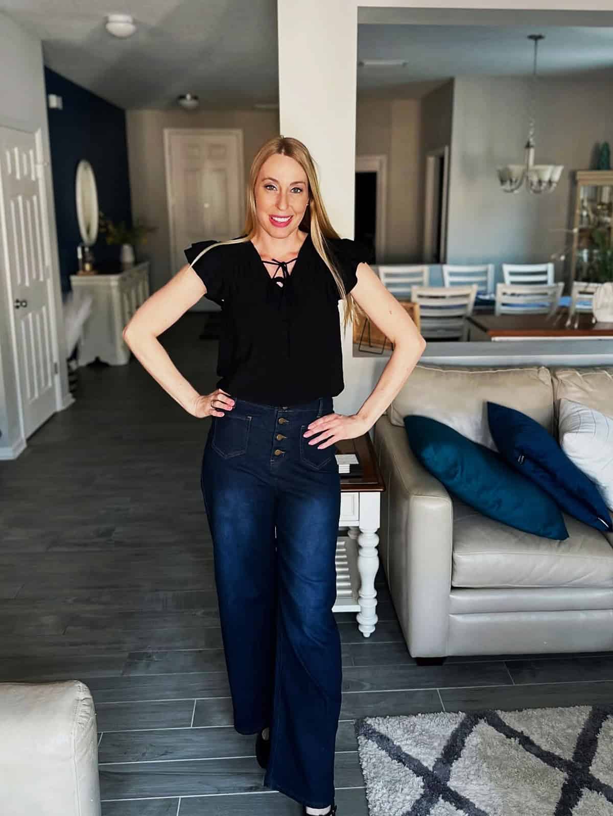 black ruffle-sleeve lace-up top with high-waisted dark wash wide-leg jeans for office attire for women over 40