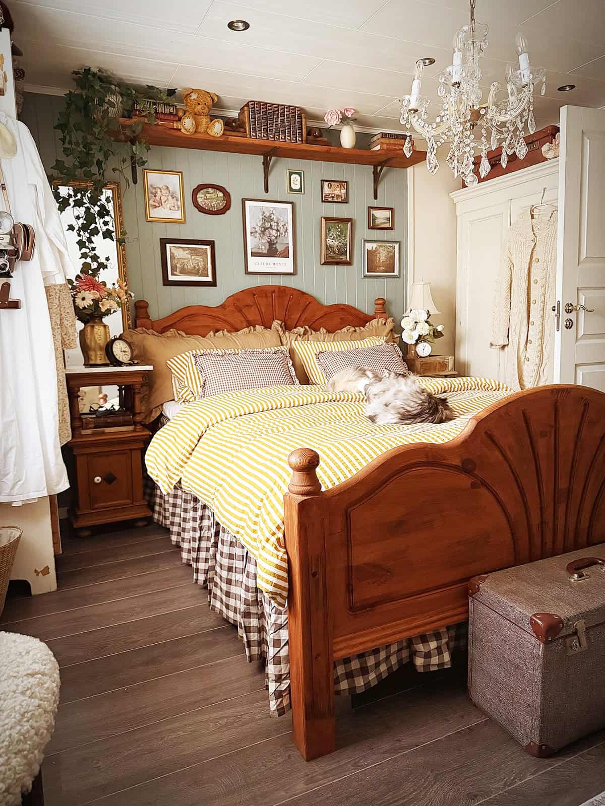 wooden bed with mixed patterns, gallery wall, shelf decor, cozy layered cottage bedroom cottagecore bedroom insp