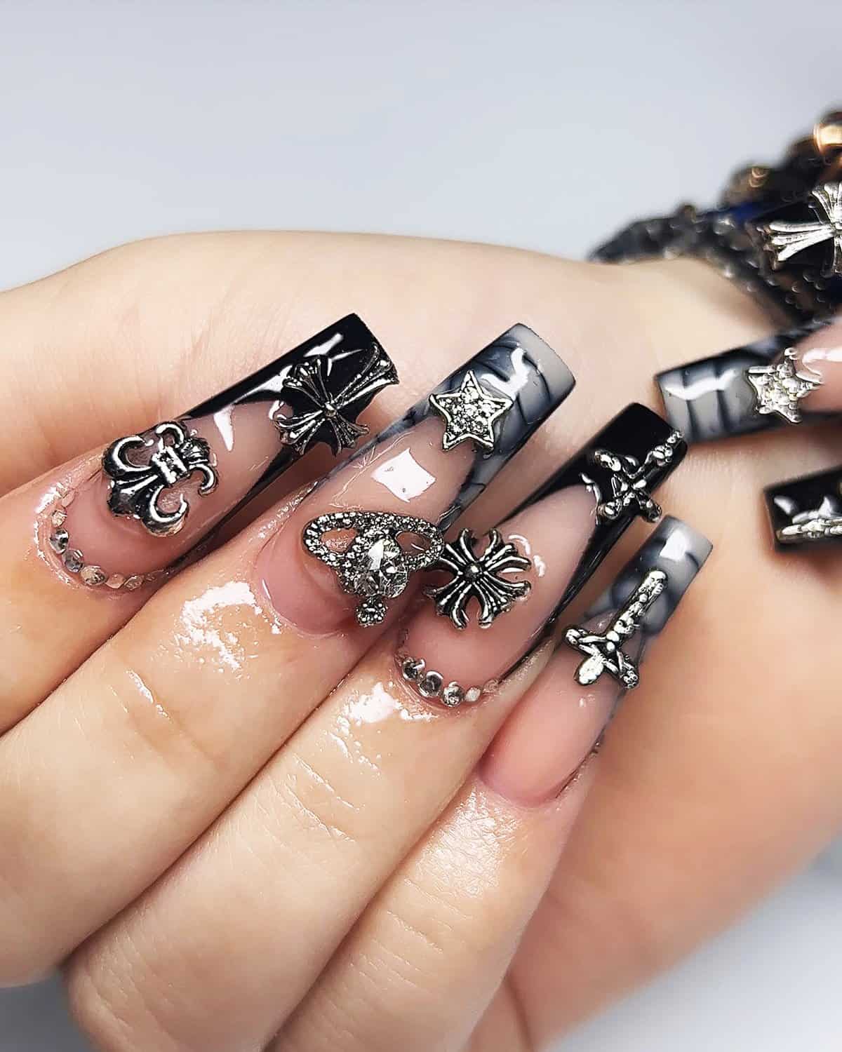 long coffin nails with smoky black tips and chunky silver gothic charms, edgy black baddie nails