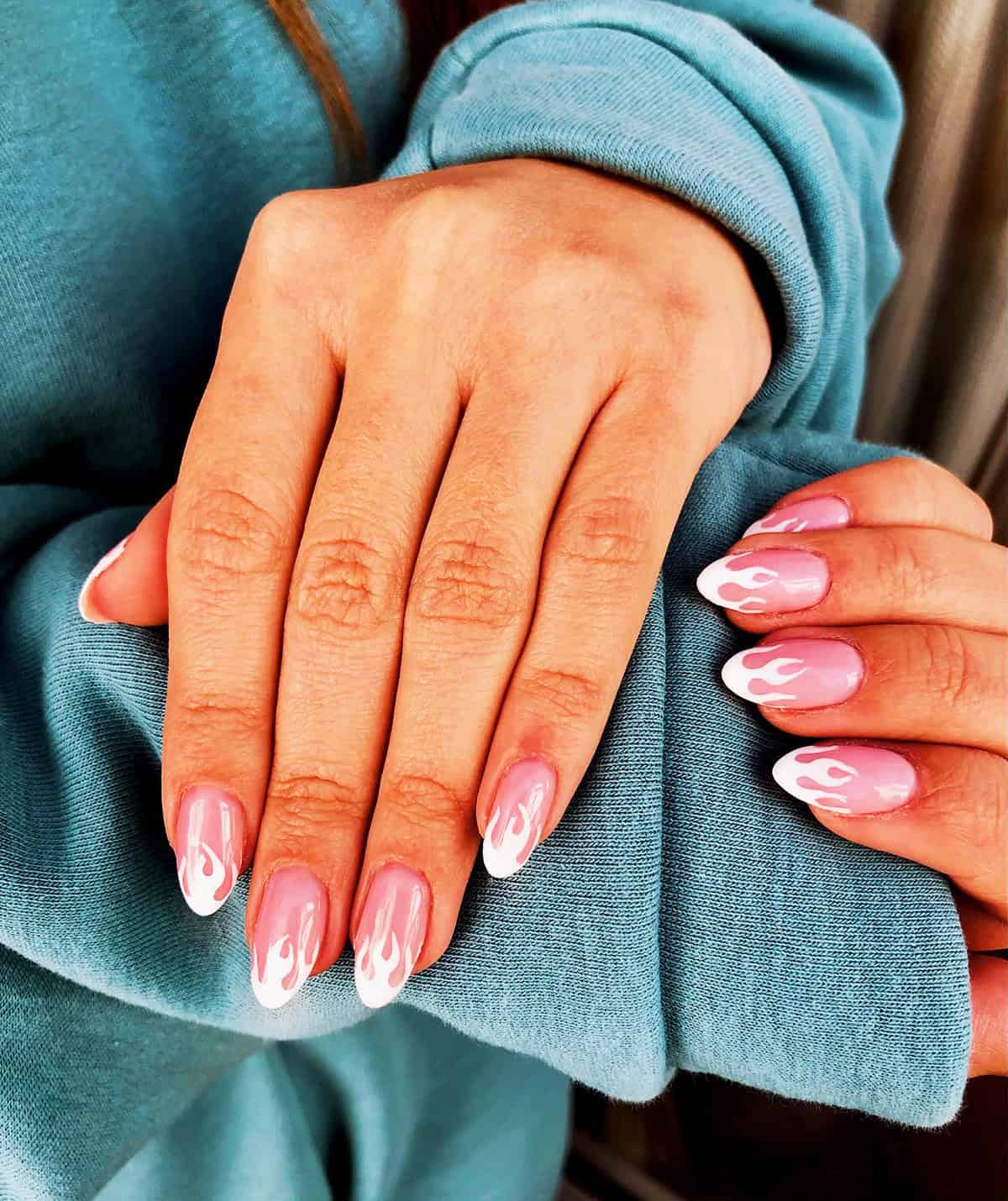 short almond milky pink nails with small white flame outlines fire nails
