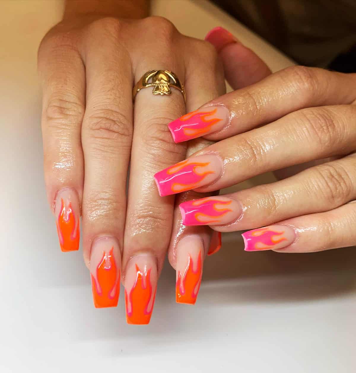 long coffin nails with sheer base and neon orange and pink contrasting flame tips fire nails