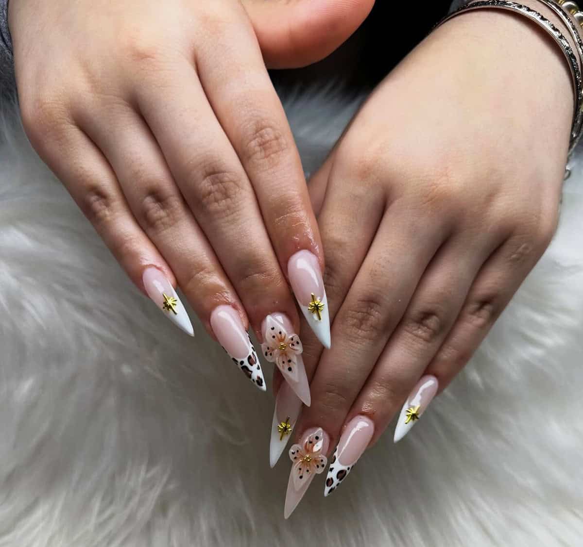nude almond nails with white tips and small gold accents baddie nails for summer