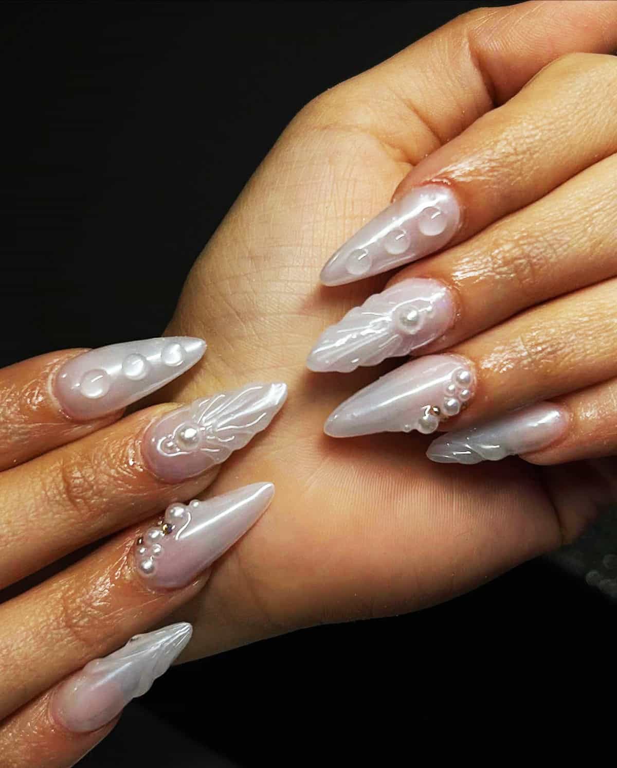 long stiletto nails with 3D sculptural pearl chrome and pearl embellishments white chrome nails