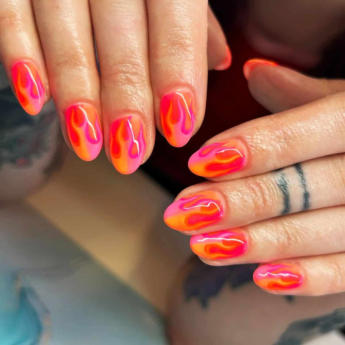 short almond nails fully covered in neon orange and hot pink flame nail art fire nails