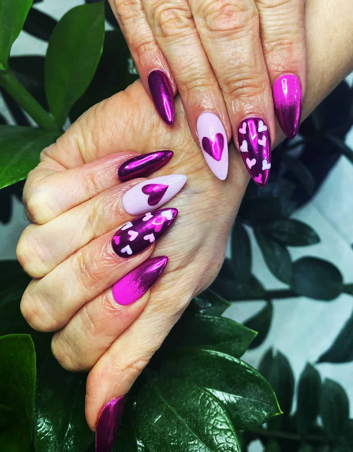 bold magenta pink chrome stiletto nails with heart details mirror shine pink chrome nails