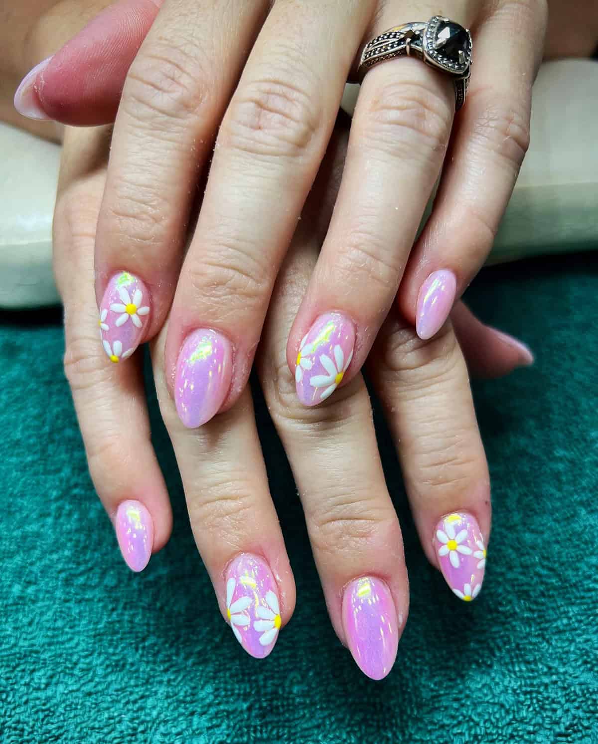 light pink chrome almond nails with daisy accents soft pearly glow pink chrome nails