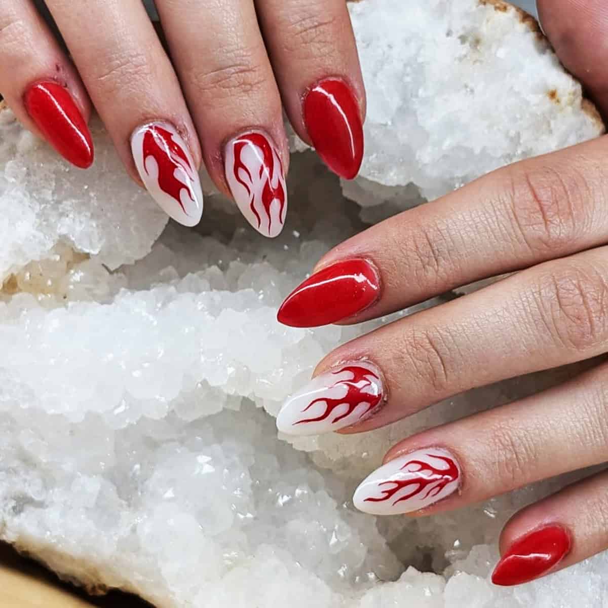 red and white almond nails with red flame nail art on white base fire nails