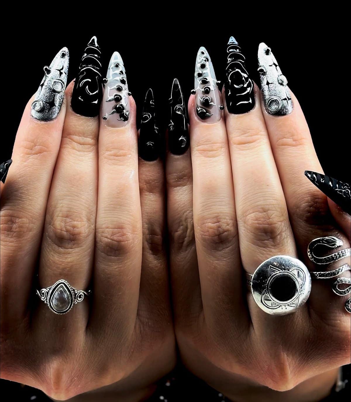 long stiletto nails with mixed black, grey, and silver 3D textures and studs, gothic glam black baddie nails