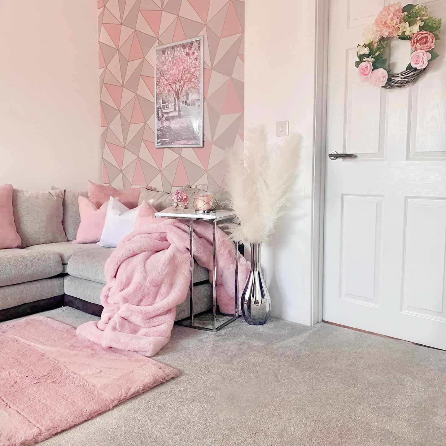pink geometric accent wall wallpaper in a living room pink wallpaper ideas home decor