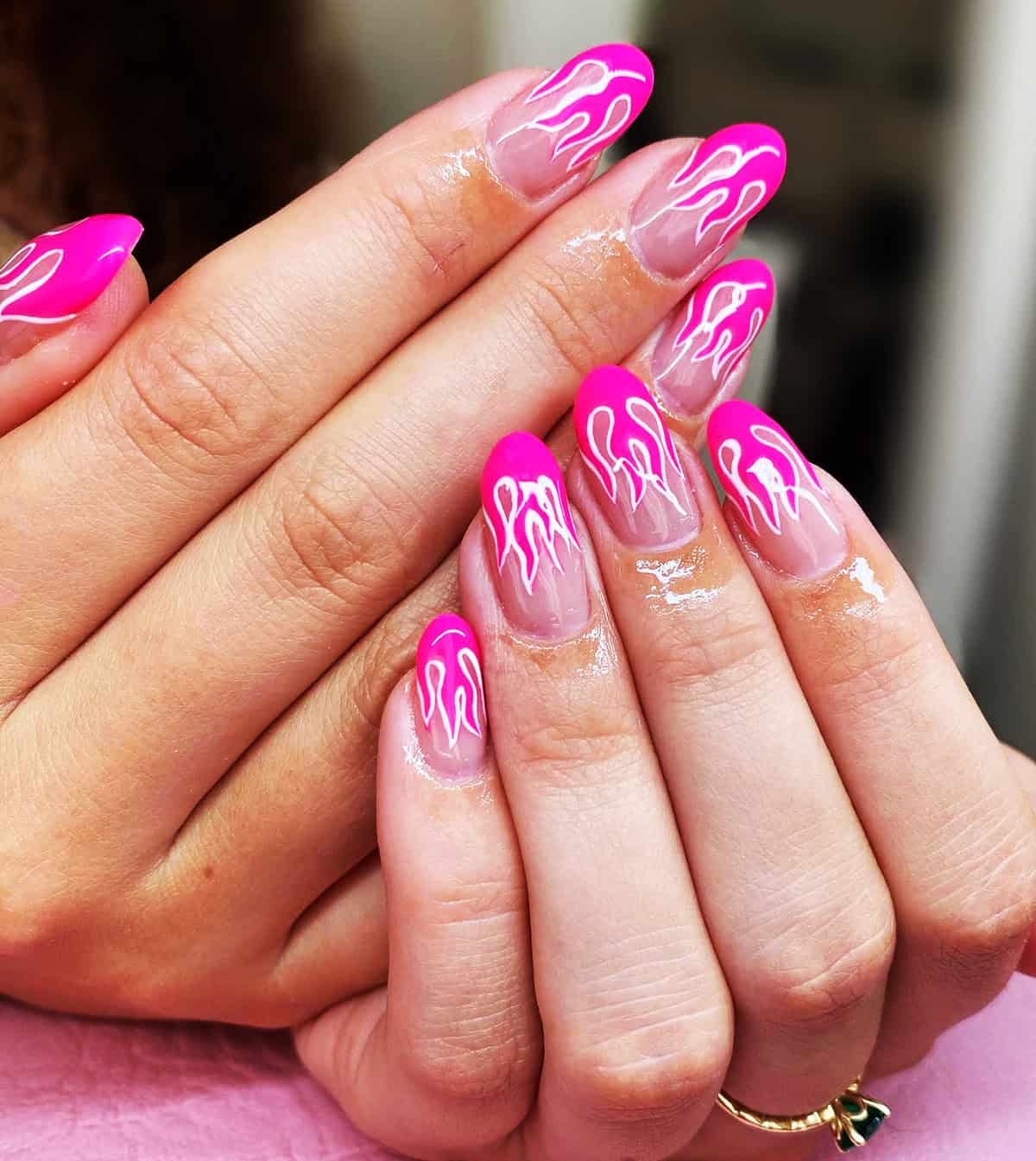 almond nails with hot pink French tips and white flame nail art on sheer base fire nails
