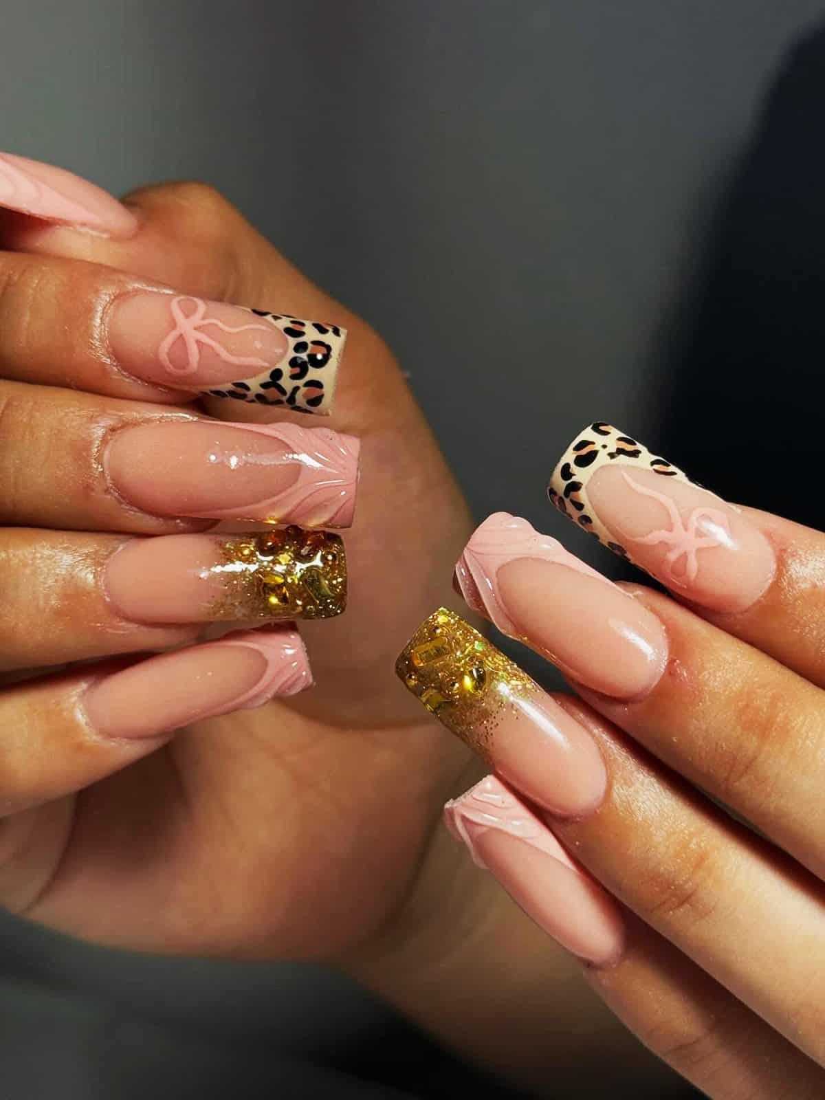 nude nails with leopard print tips and gold glitter accent nails baddie nails for summer