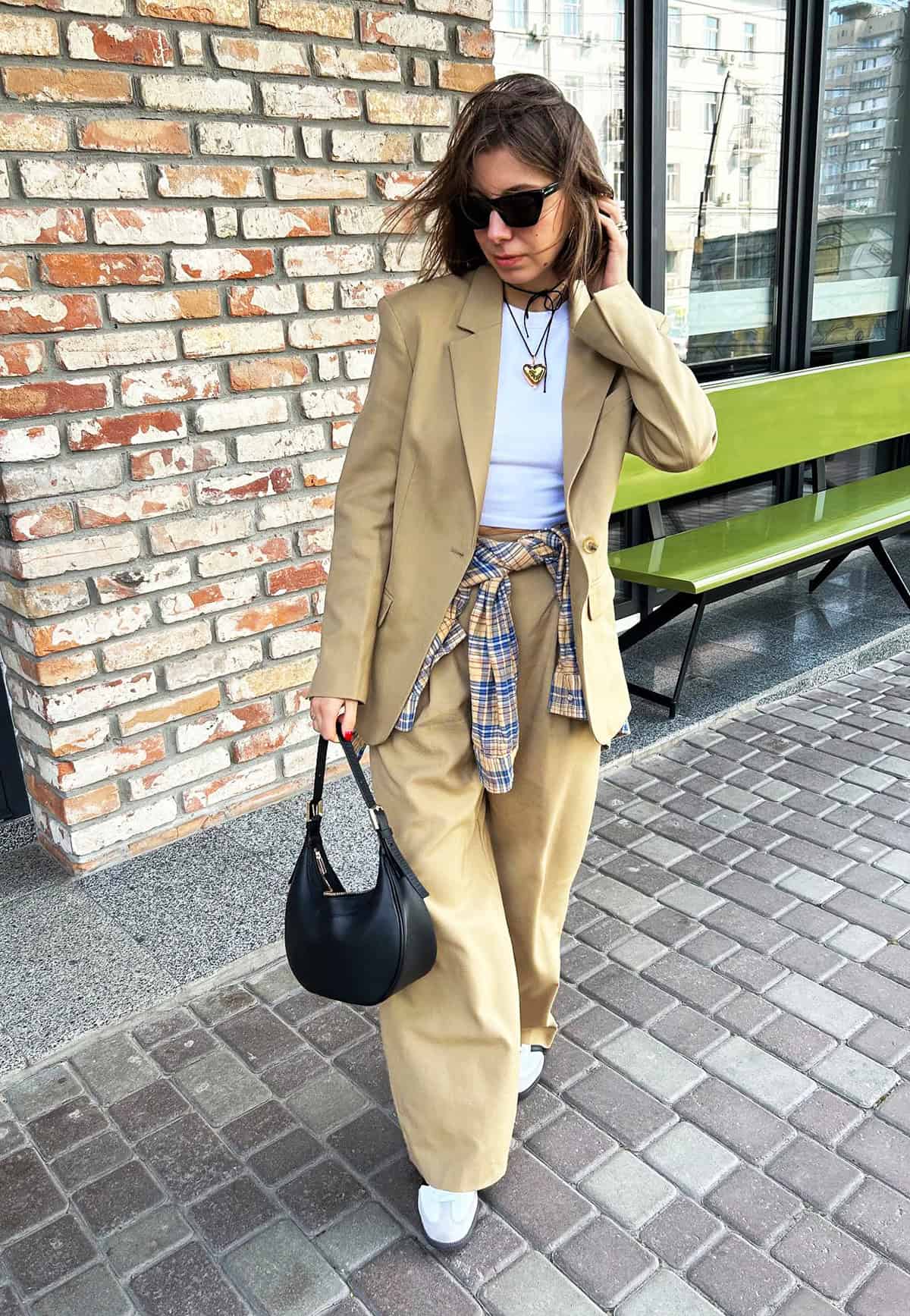 tan oversized blazer and wide-leg trouser set with white tee and plaid shirt tied at waist for office attire for women over 40