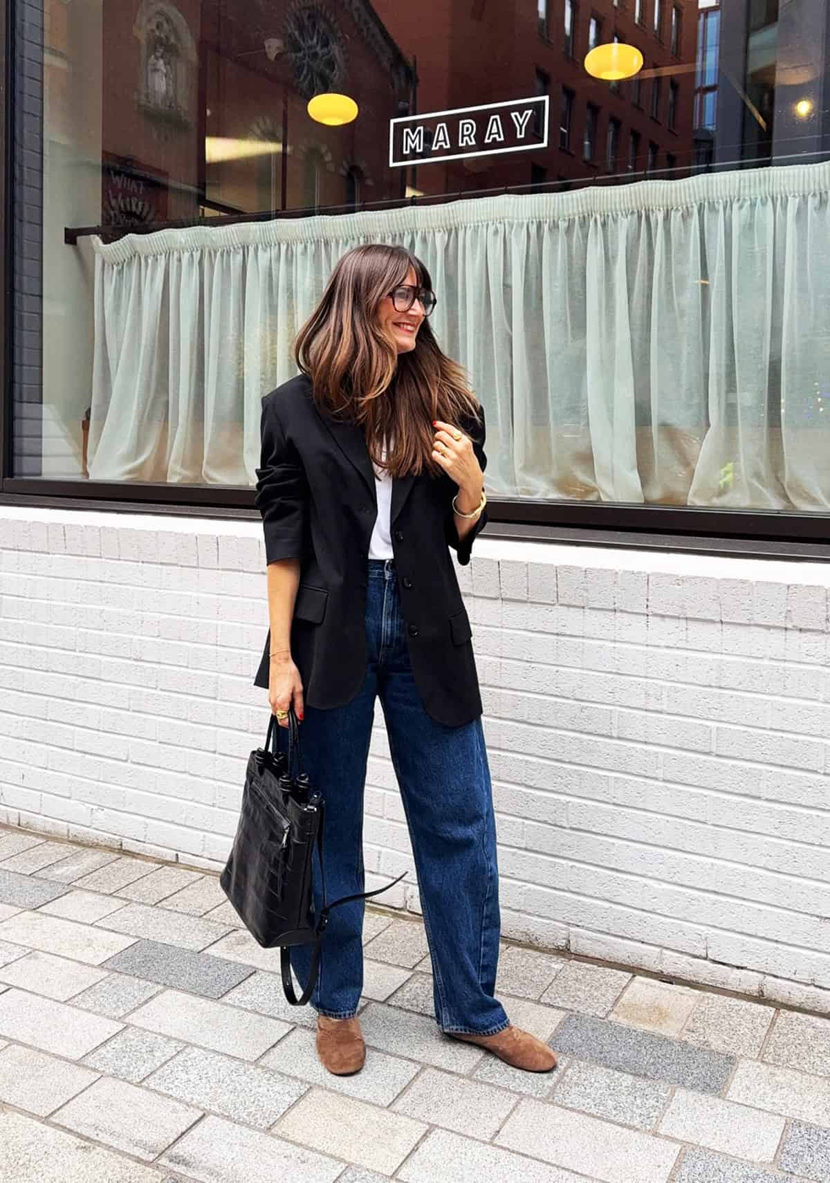 oversized black blazer with white tee, wide-leg dark wash jeans and tan suede mules for office attire for women over 40