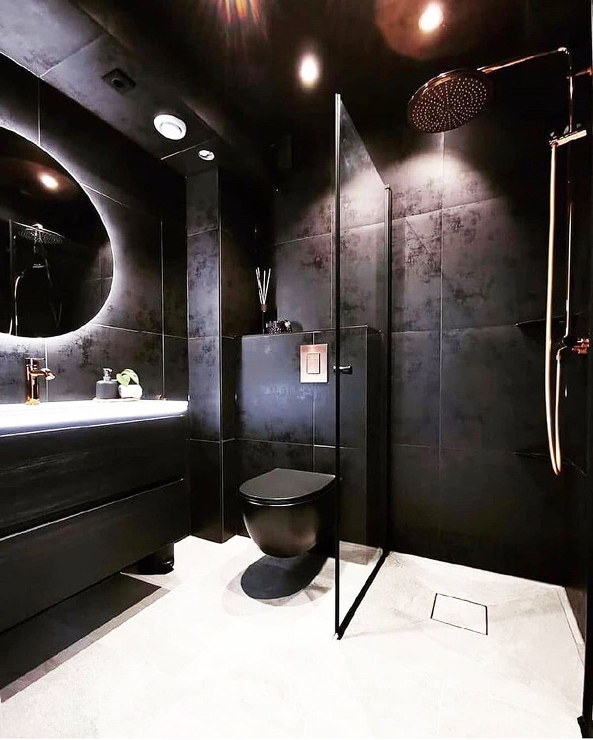 matte black bathroom with light flooring and glass shower opening up the space, black bathroom ideas