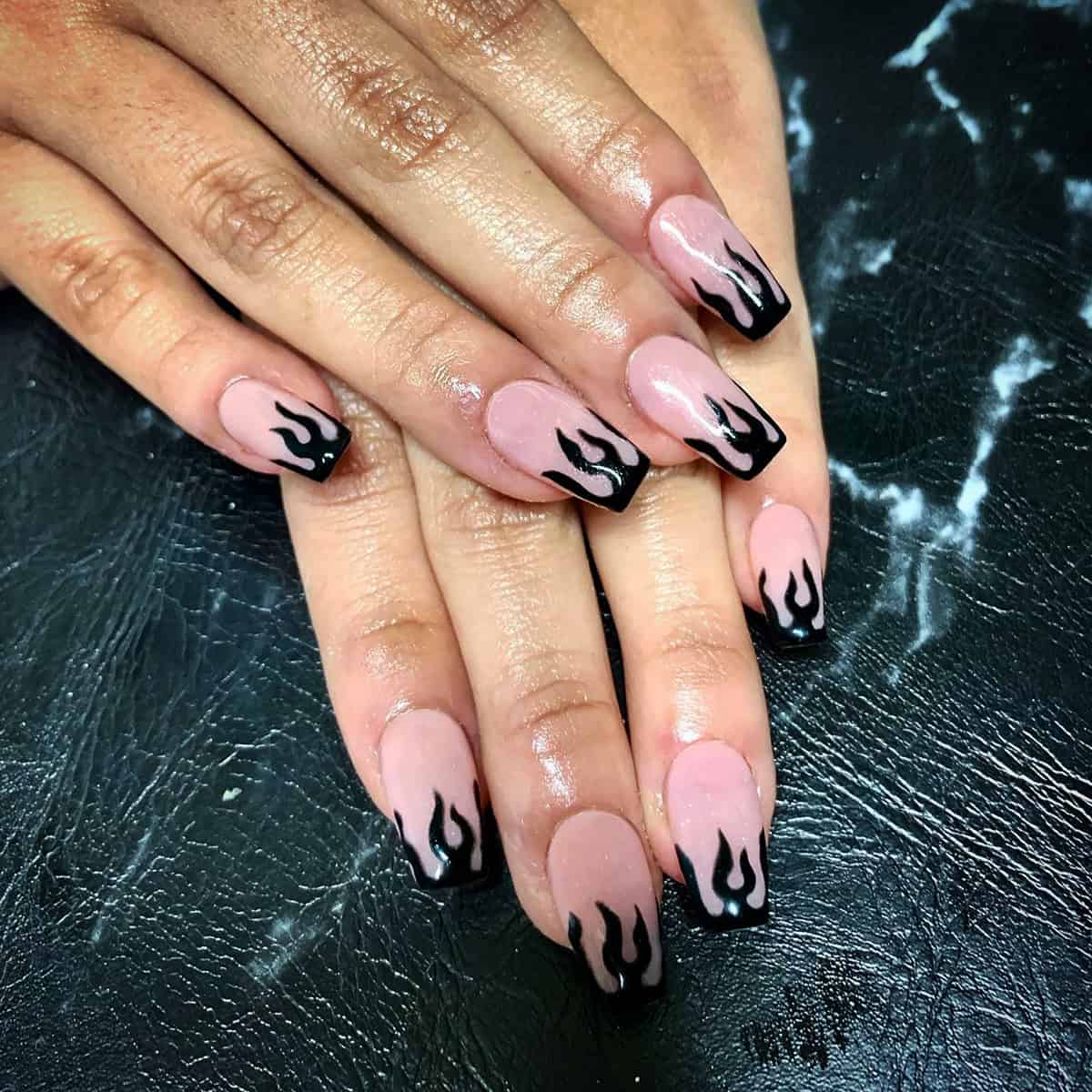 short coffin nails with pale pink base and black flame French tip nail art fire nails