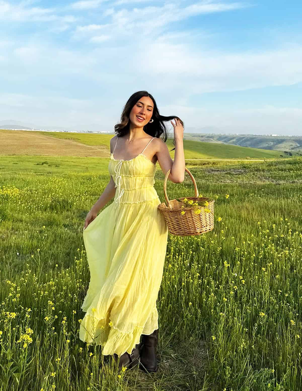 yellow prairie maxi dress in a wildflower field with basket cottagecore summer dresses