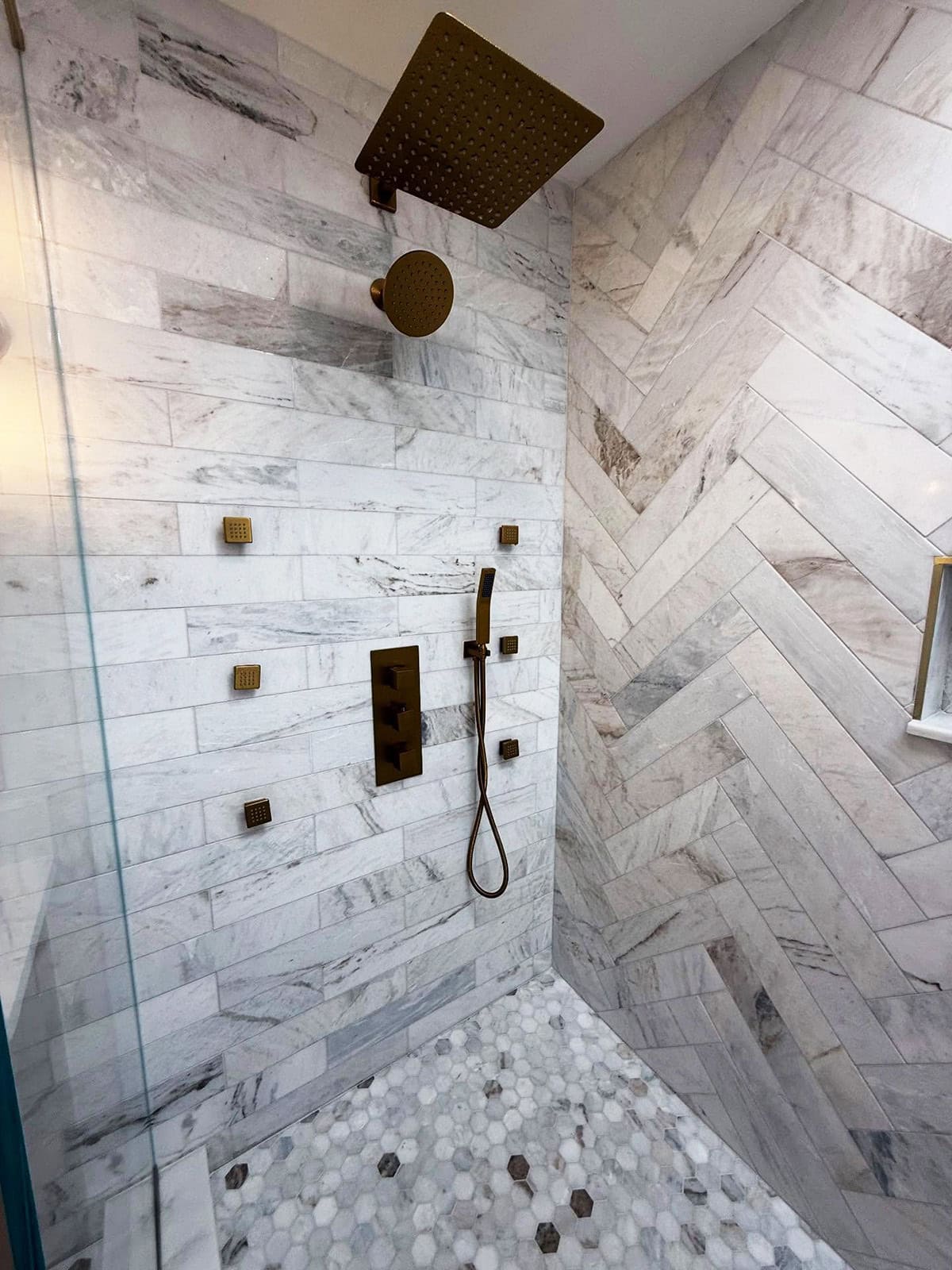 herringbone marble tile shower wall  bathroom ideas
